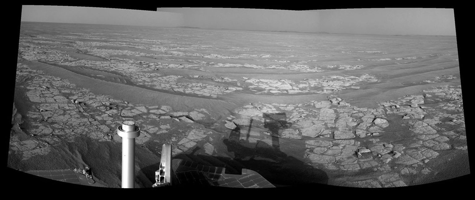 This mosaic of images from the navigation camera on NASA's Mars Exploration Rover Opportunity shows a terrain that includes light-toned bedrock and darker ripples of wind-blown sand.