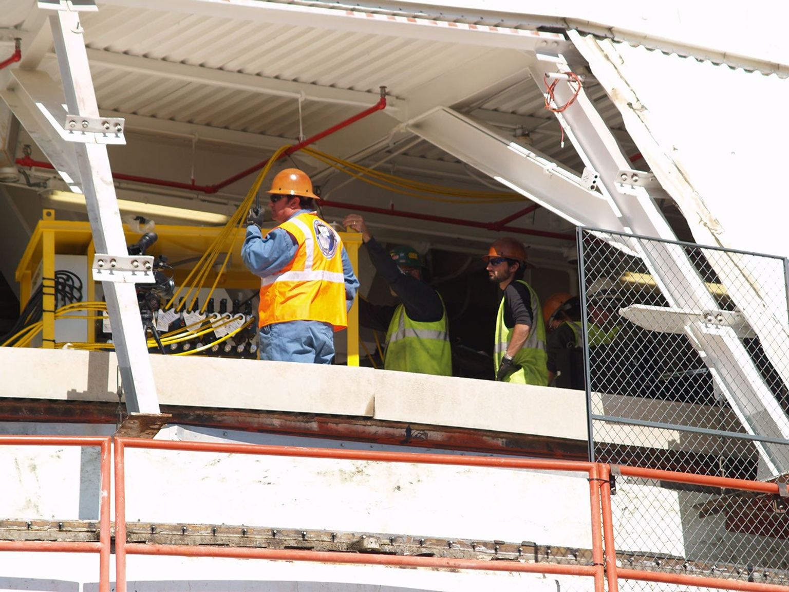 A worker at NASA's Deep Space Network's Goldstone Deep Space Communications Complex radios to his colleagues that 12 jacks are ready to lift the upper section of the giant 'Mars antenna.'