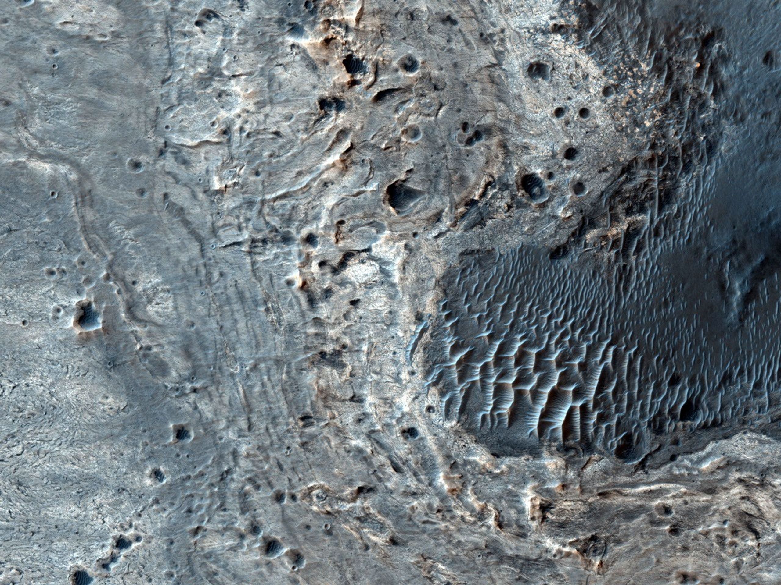 This image from NASA's Mars Reconnaissance Orbiter shows a number of unusual, quasi-circular structures that apparently formed within bright flows in Meridiani Planum.