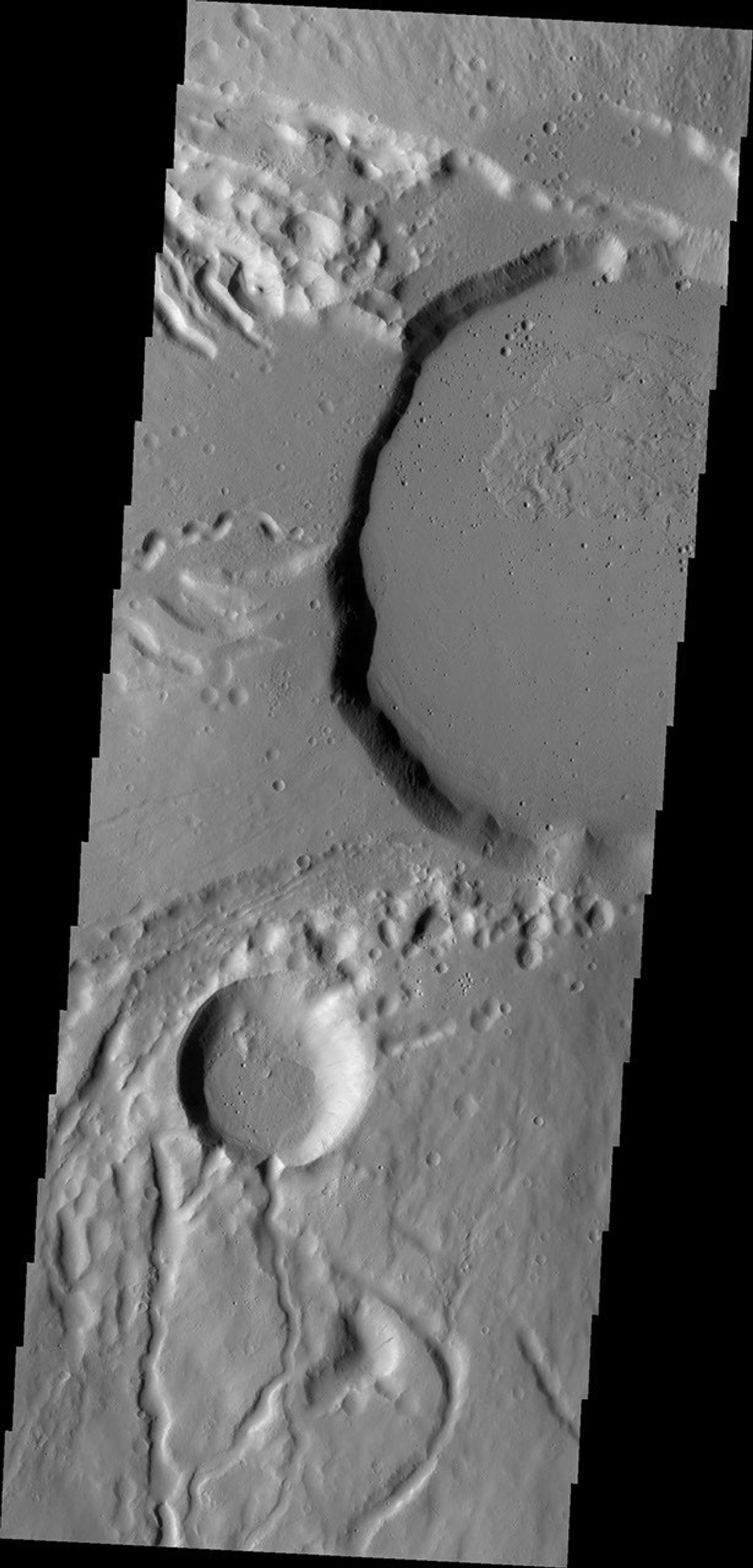 This image from NASA's Mars Odyssey shows part of the summit caldera of Ceraunius Tholus, one of the smaller volcanoes of the Tharsis region.