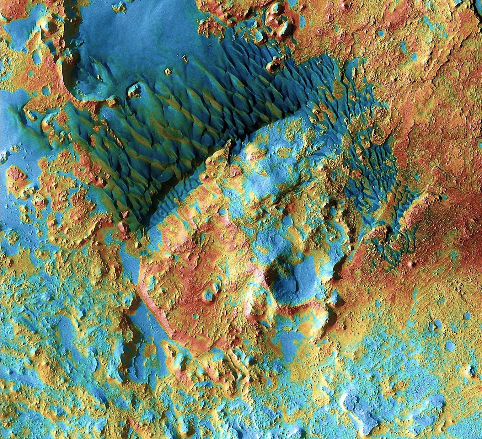 Sand dunes shaped like blue-black flames lie next to a central hill within an unnamed crater in eastern Arabia on Mars. This image is part of an 'All Star' set marking the occasion of NASA's Mars Odyssey as the longest-working Mars spacecraft in history.