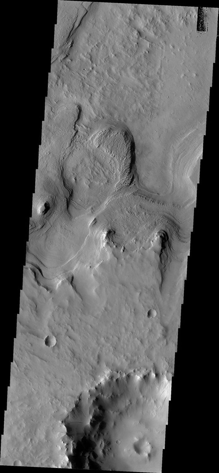 This image from NASA's Mars Odyssey shows layered material surrounding an unnamed crater in Terra Sabaea.