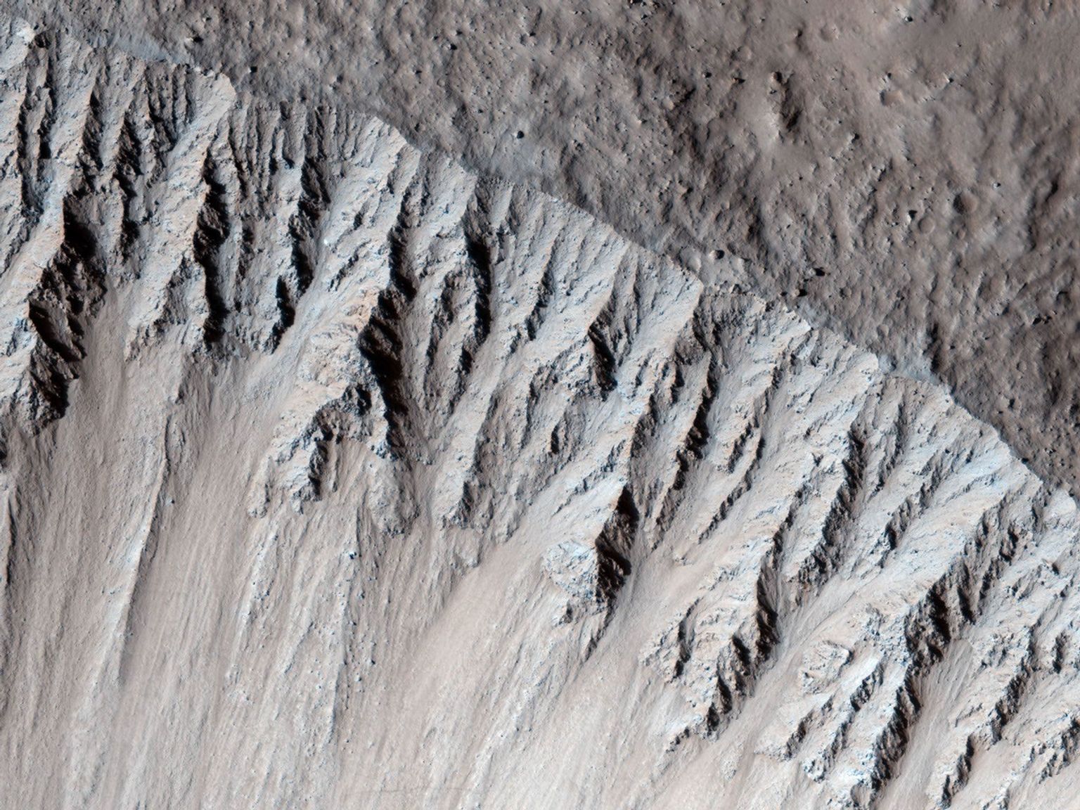 This image from NASA's Mars Reconnaissance Orbiter is one of the rare examples of a fresh 'lunar-like' crater on Mars. The impact crater formed in the Tharsis region.