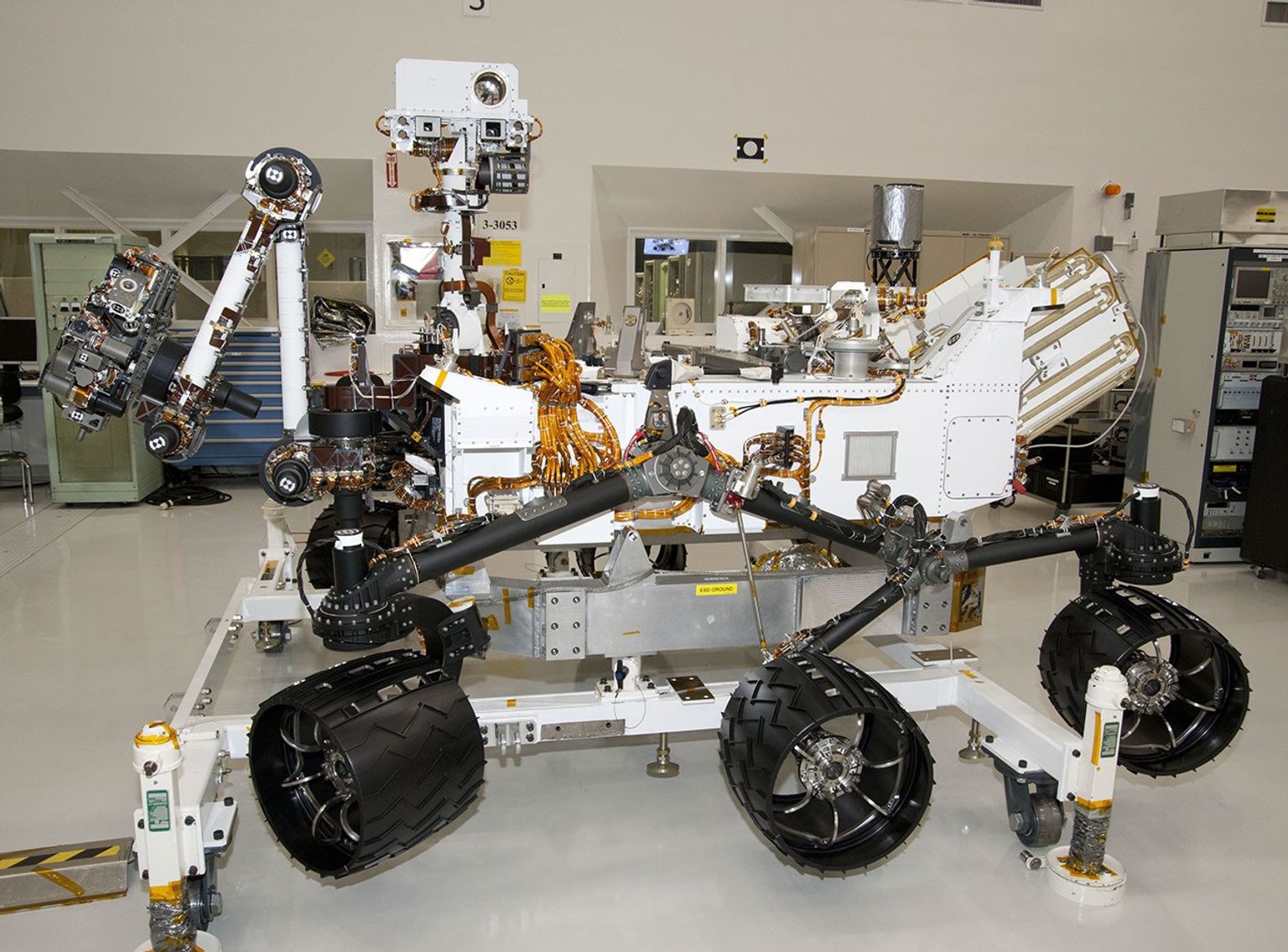 The rover for NASA's Mars Science Laboratory mission, named Curiosity, is about 3 meters (10 feet) long, not counting the additional length that the rover's arm can be extended forward. The front of the rover is on the left in this side view.
