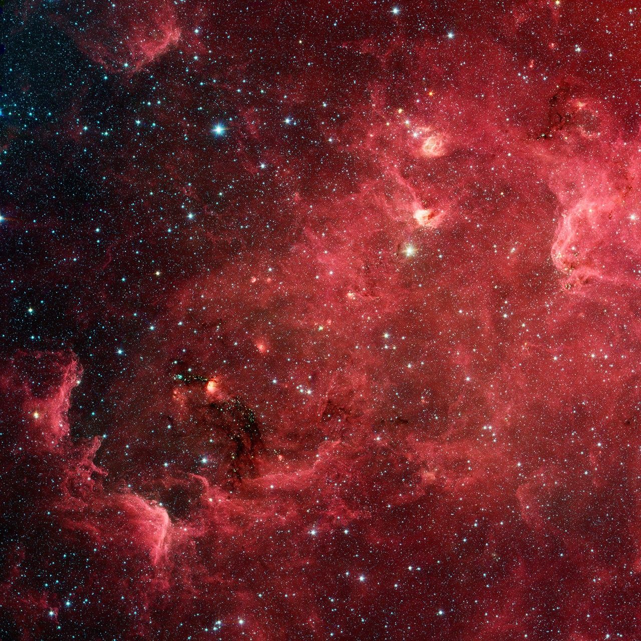This infrared image from NASA's Spitzer Space Telescope shows a swirling landscape of stars known as the North America nebula. Clusters of young stars (about one million years old) can be found throughout the image.