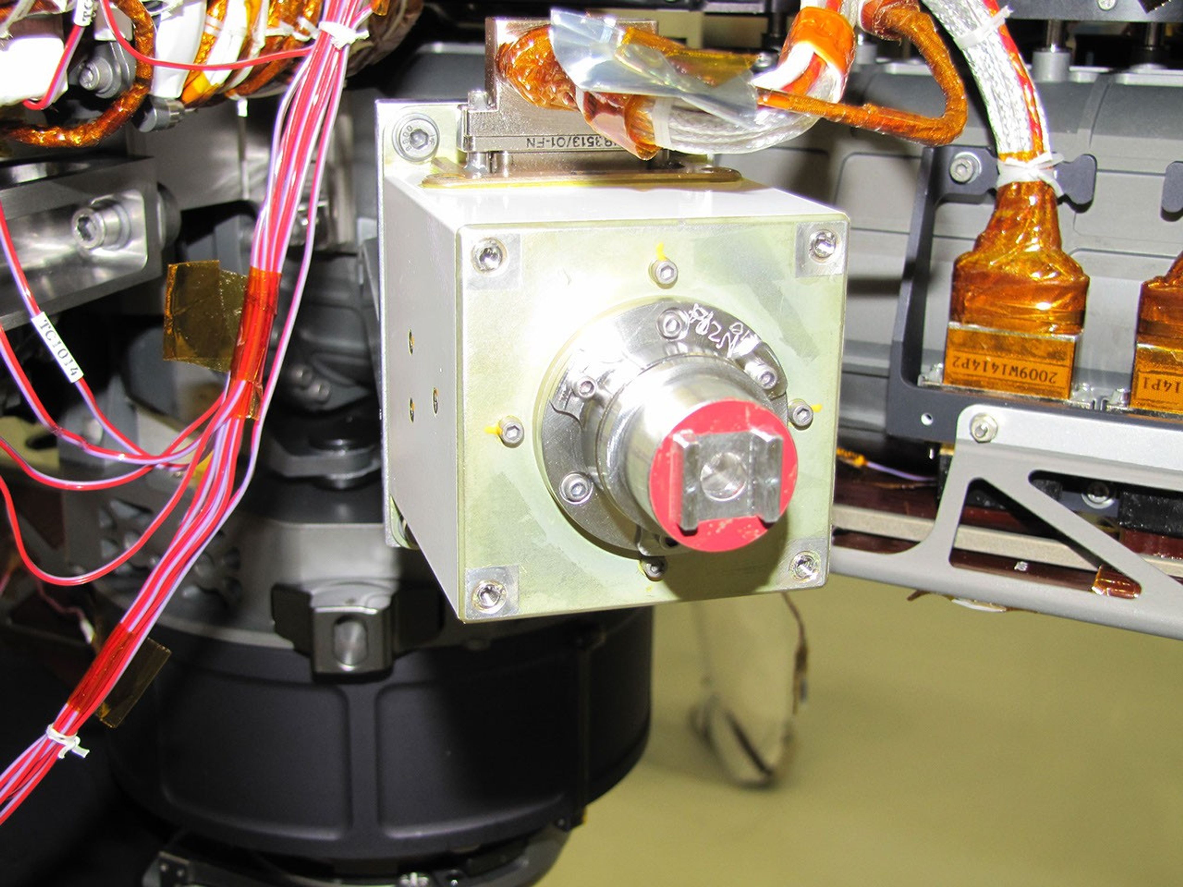 The sensor head on the Alpha Particle X-ray Spectrometer instrument was installed during testing at NASA's Jet Propulsion Laboratory. The instrument is part of NASA's Curiosity rover.