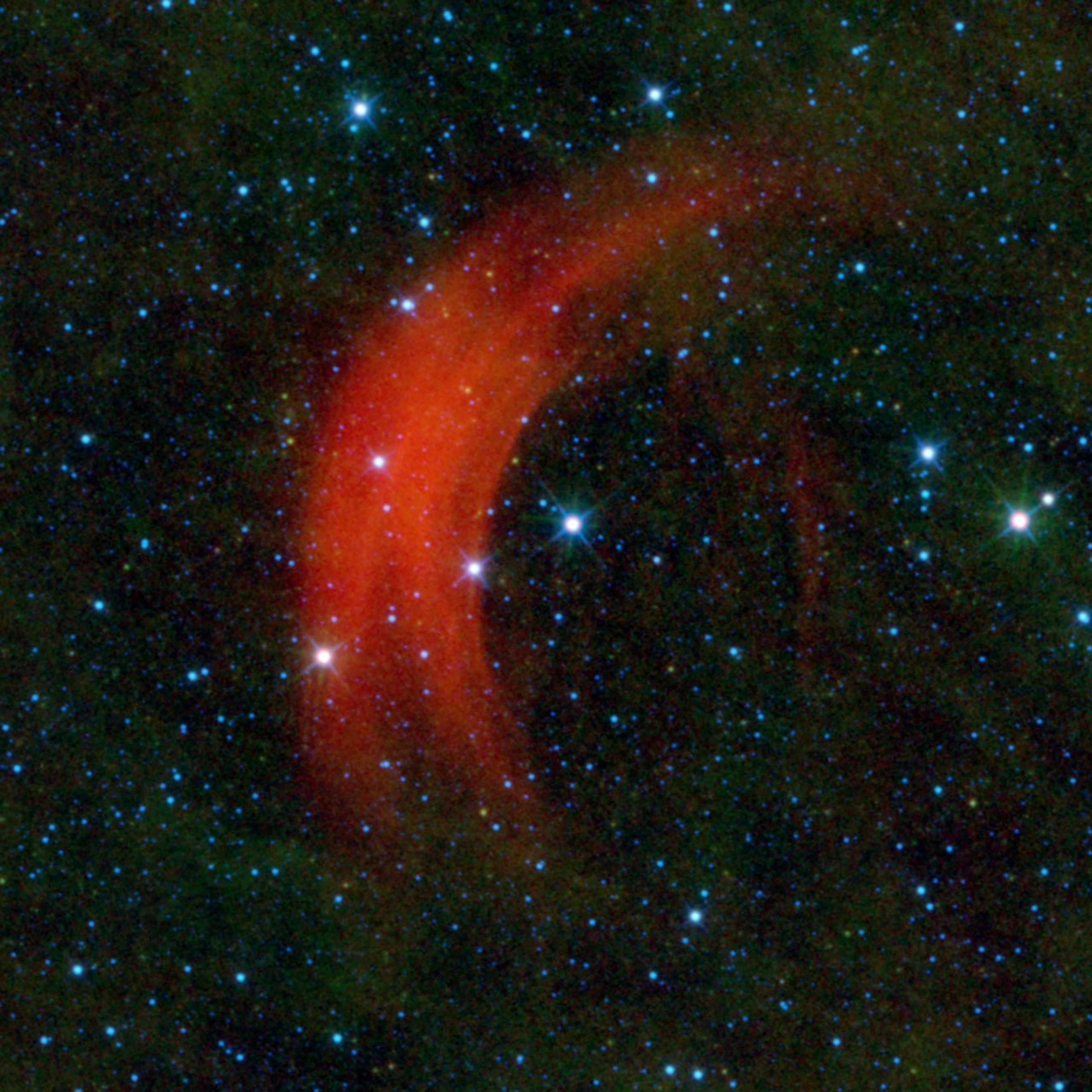 NASA's Wide-field Infrared Survey Explorer captured this image of the star Alpha Camelopardalis, or Alpha Cam speeding through the sky like a motorcyclist zipping through rush-hour traffic. The supergiant star Alpha Cam is the bright star in the middle.