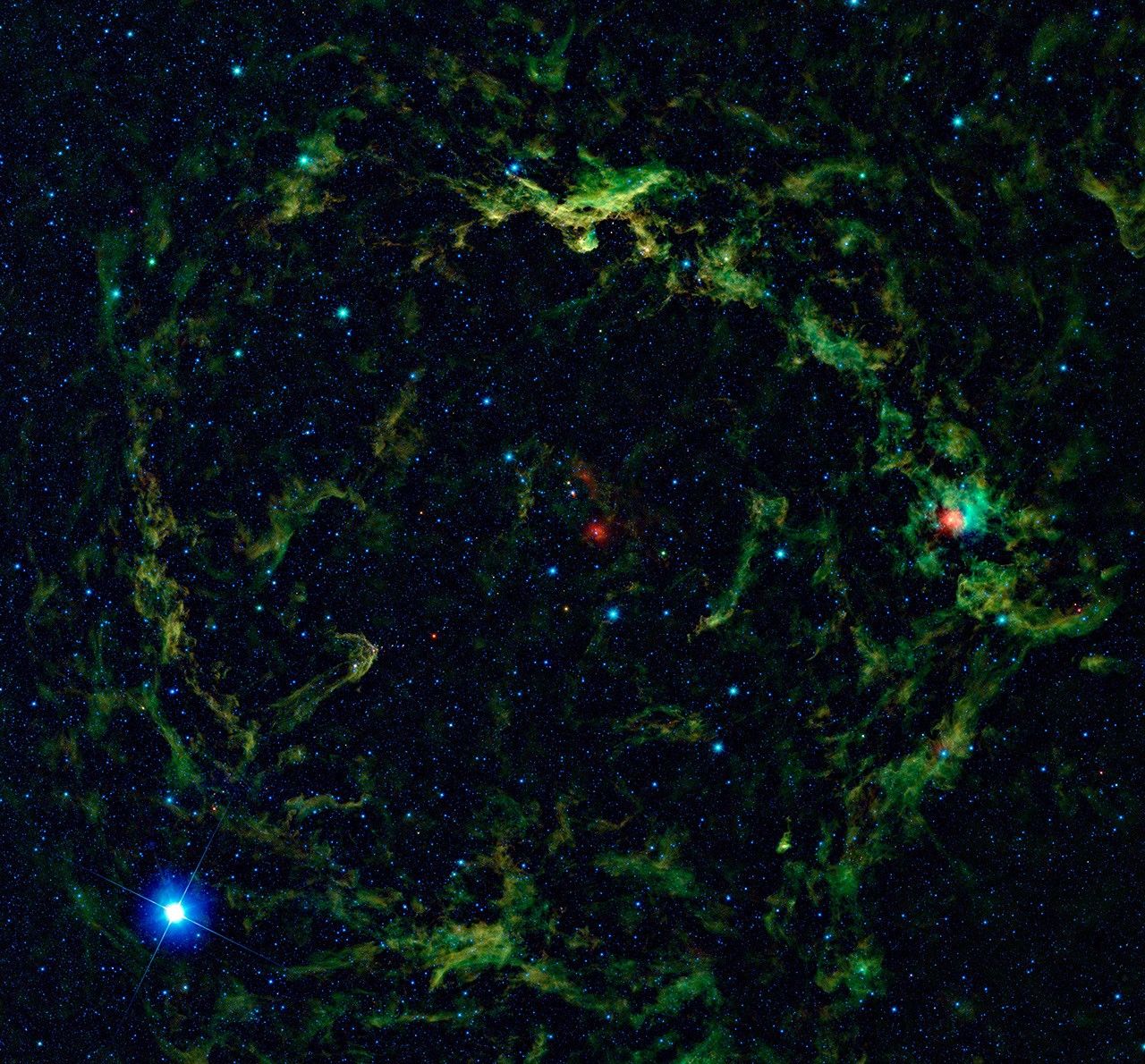 NASA's Wide-field Infrared Survey Explorer, shows a giant nebula around Lambda Orionis, inflating Orion's head to huge proportions.
