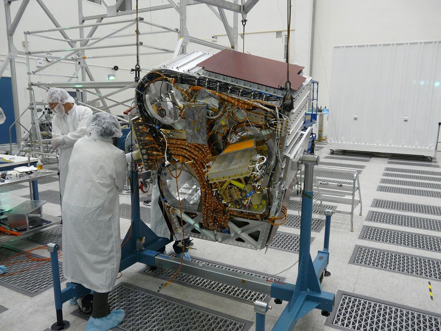 Engineers check cables on back of Aquarius instrument in the clean room at NASA's Jet Propulsion Laboratory in Pasadena, Calif.