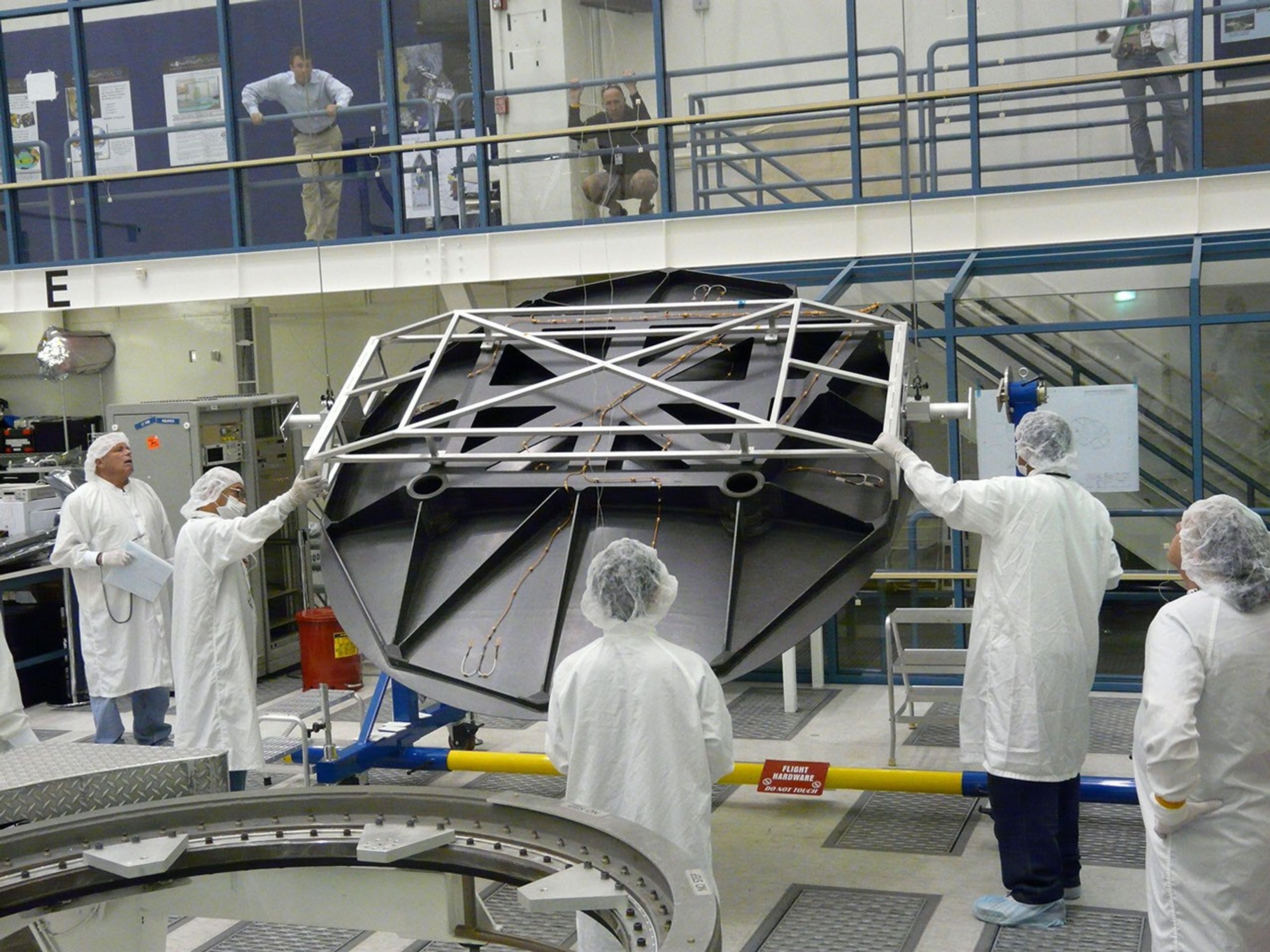 Engineers test Aquarius 2.5 meter reflector in the clean room at NASA's Jet Propulsion Laboratory in Pasadena, Calif.