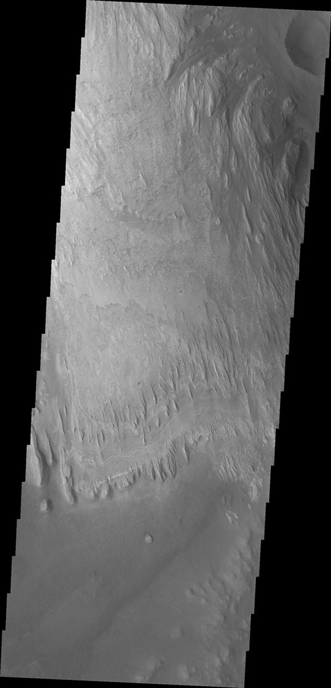 Wind has eroded the deposit on the floor of Gale Crater in this image captured by NASA's 2001 Mars Odyssey.