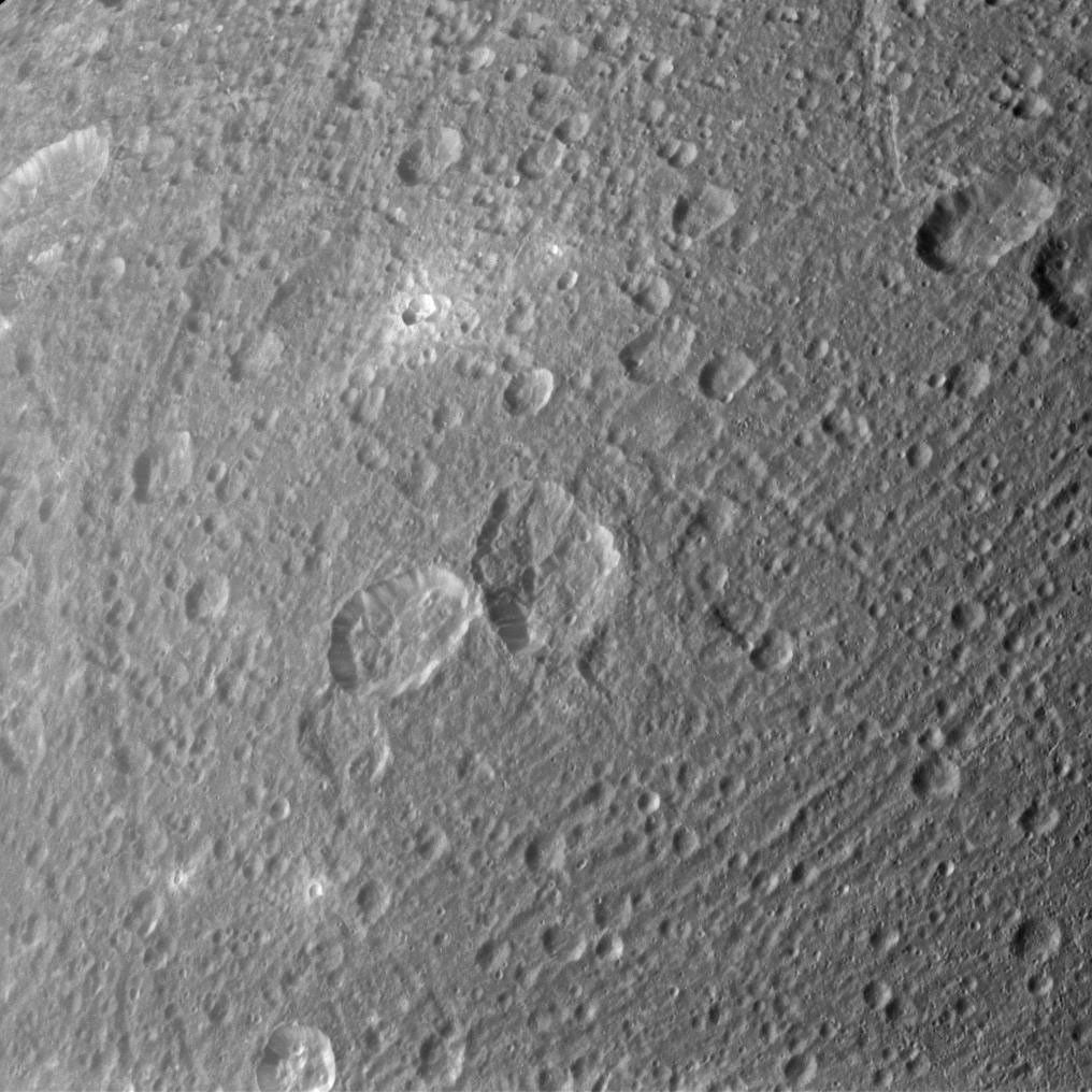 Ejected material appears bright around some of Dione's craters in the image taken during NASA's Cassini spacecraft's flyby of the moon on March 28, 2012.