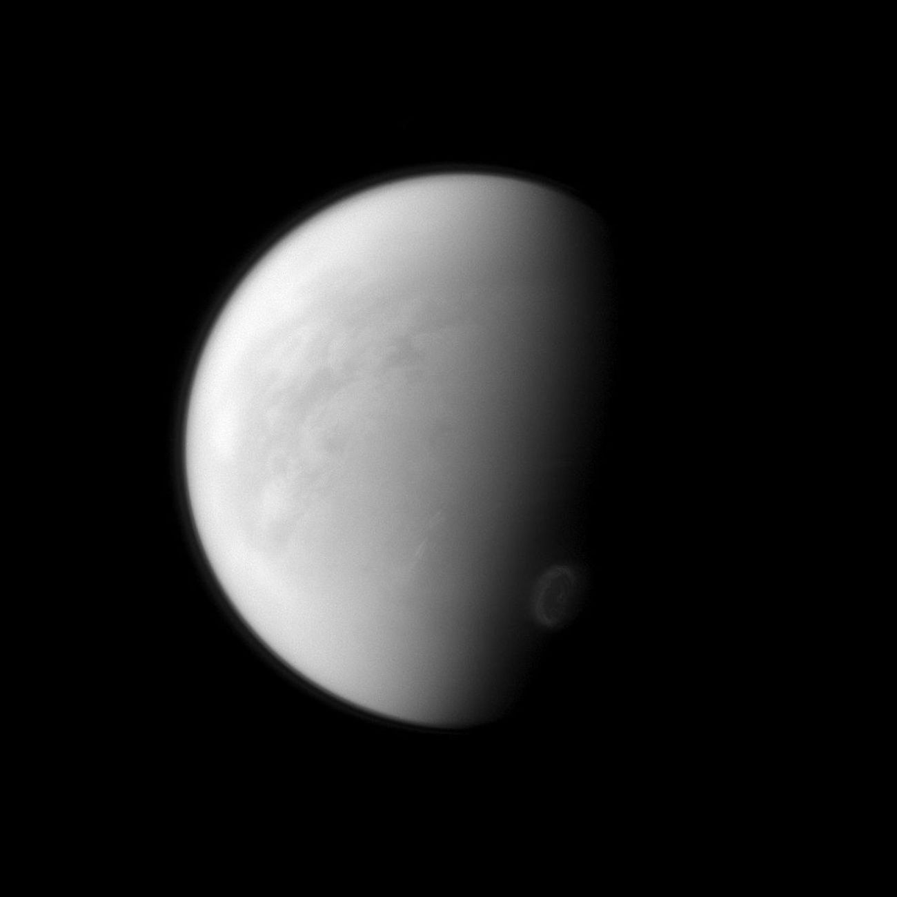 Titan's swirling south-polar vortex stands out brightly against the other clouds of the south pole (lower right) in this image captured by NASA's Cassini spacecraft.