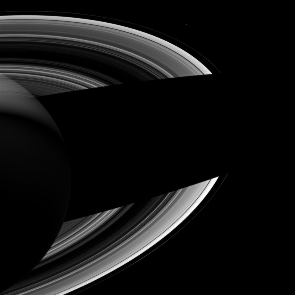 Saturn's small moons Atlas, Prometheus, and Epimetheus keep each other company in this image from NASA's Cassini spacecraft of the planet's night side. It seems fitting that they should do so since in Greek mythology, their namesakes were brothers.