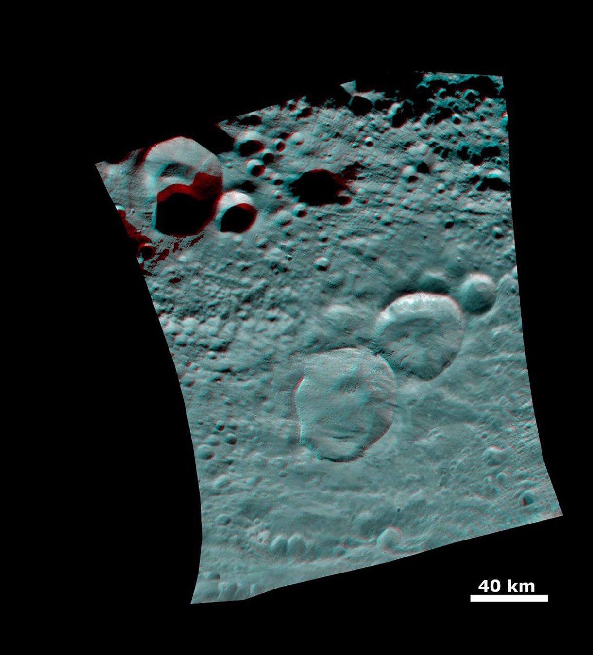 This 3D image shows the topography of Vesta's three craters, informally named the 'Snowman,' obtained by the framing camera instrument aboard NASA's Dawn spacecraft on August 6, 2011. You need 3D glasses to view this image.