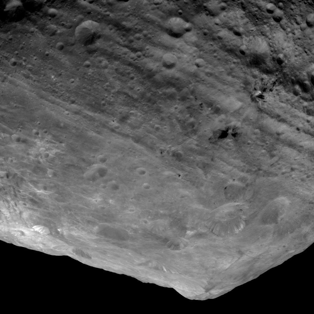This image from NASA's Dawn spacecraft is of the south pole region of the asteroid Vesta, a mountain is rising approximately 9 miles (15 kilometers) above the floor of a crater.