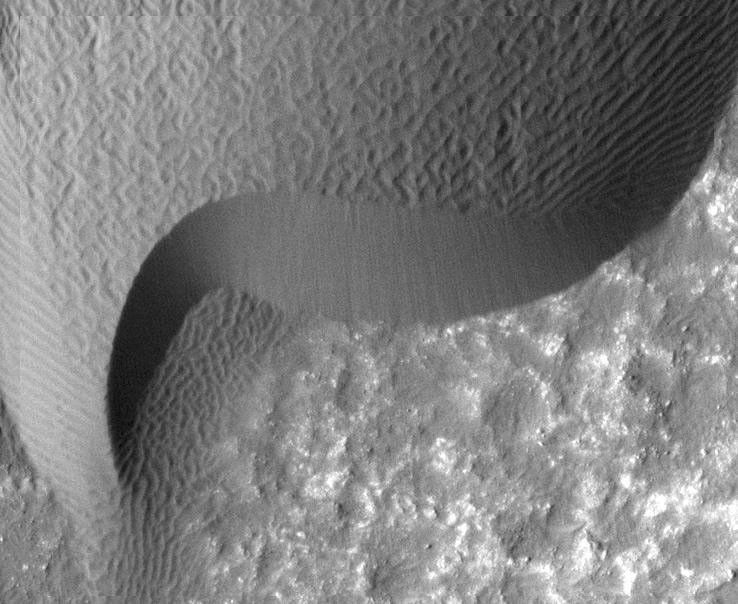 A rippled dune front in Herschel Crater on Mars moved an average of about two meters (about two yards) between March 3, 2007 and December 1, 2010, as seen in one of two images from NASA's Mars Reconnaissance Orbiter.