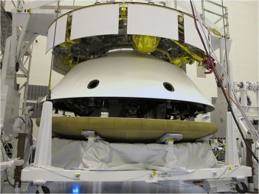 During final stacking of NASA's Mars Science Laboratory spacecraft, the heat shield is positioned for integration with the rest of the spacecraft in this photograph from inside the Payload Hazardous Servicing Facility at NASA Kennedy Space Center, Fla.