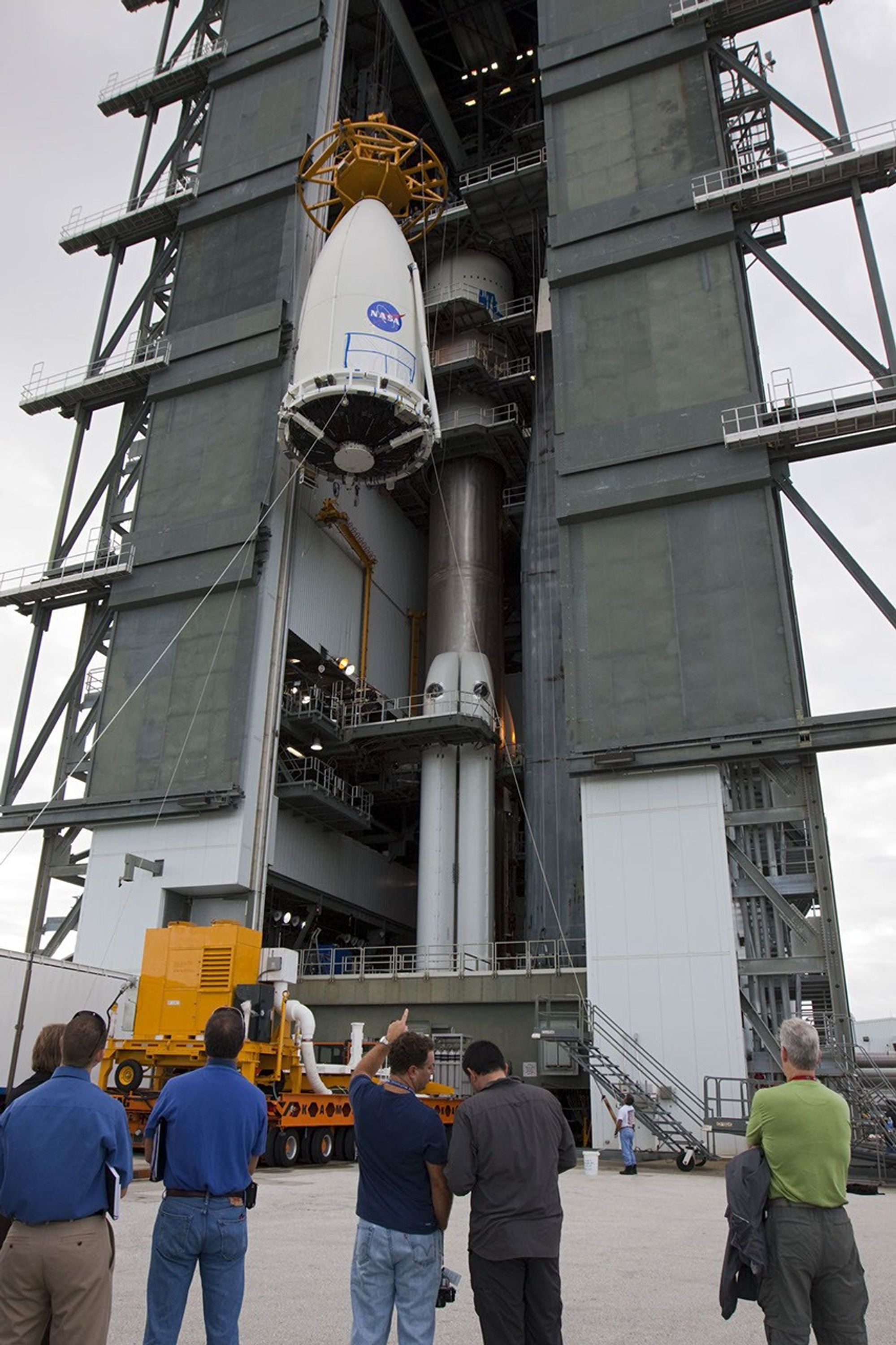 Employees at Space Launch Complex 41 of Cape Canaveral Air Force Station, Fla., keep watch as the payload fairing containing NASA's Mars Science Laboratory spacecraft is lifted up the side of the Vertical Integration Facility on Nov. 3, 2011.