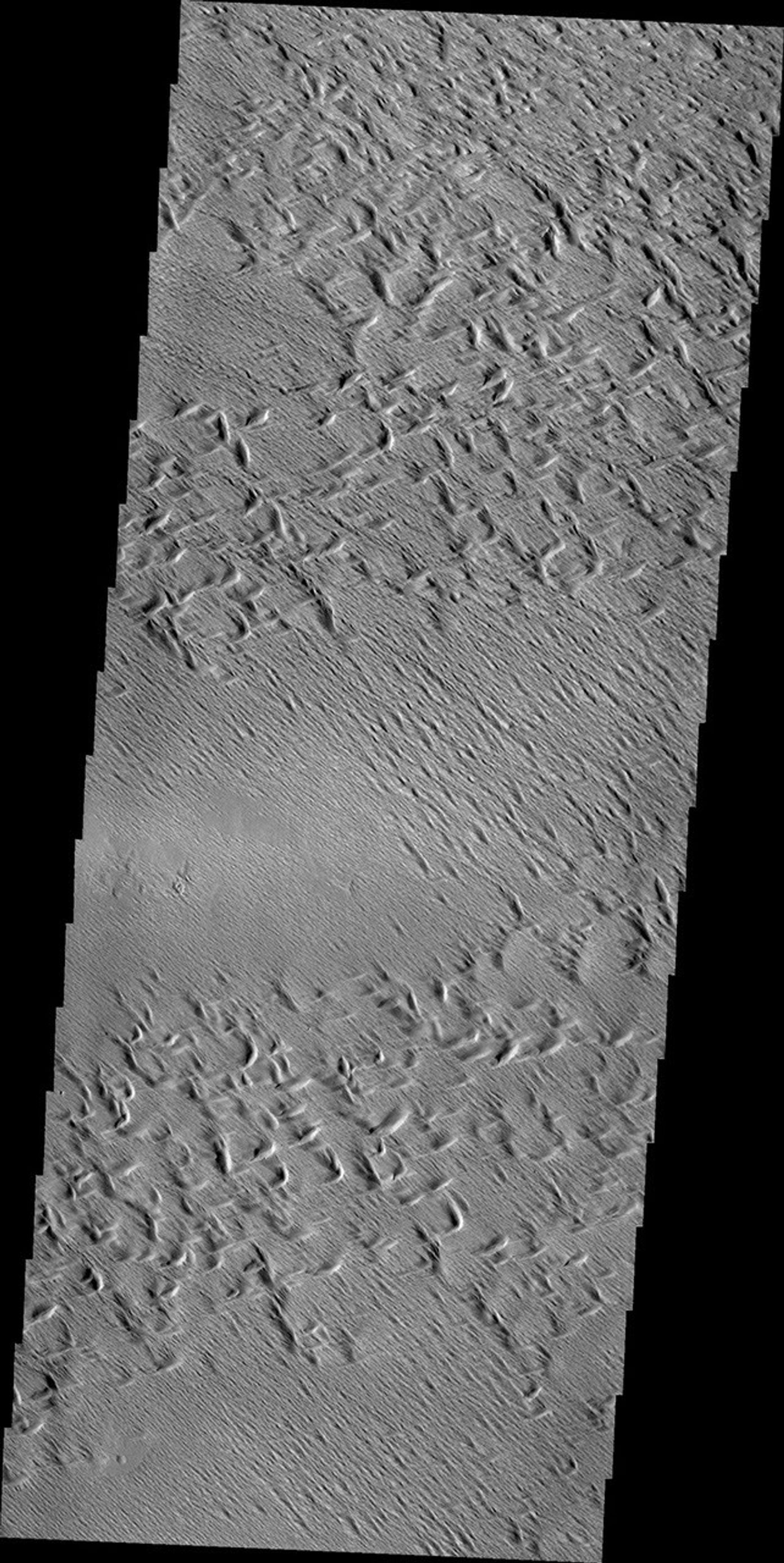 Wind erosion has created this complex surface south of Olympus Mons as seen by NASA's 2001 Mars Odyssey spacecraft.