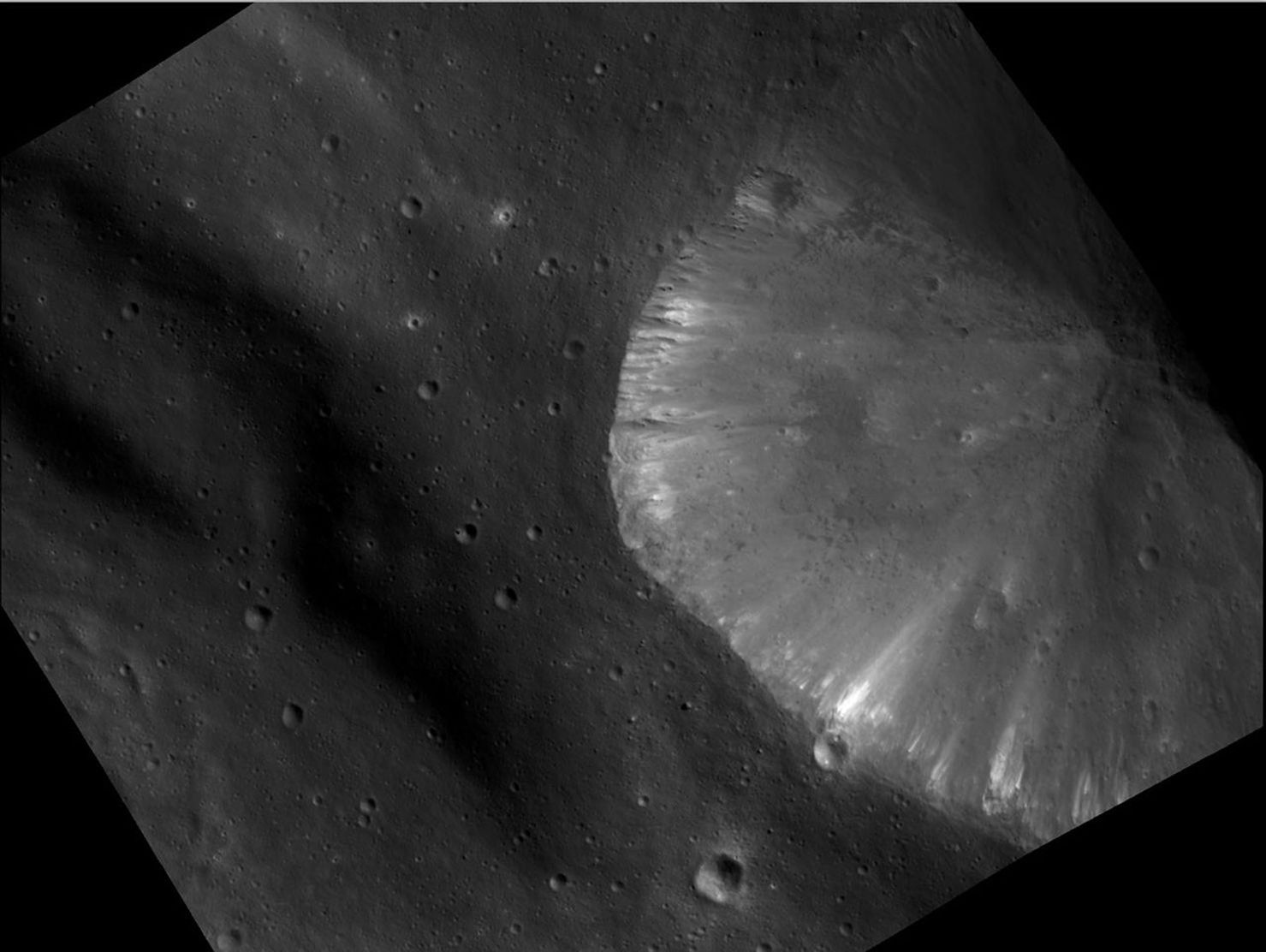This image from NASA's Dawn spacecraft shows the brightest area seen on asteroid Vesta so far. It shows a crater located inside the rim of the Rheasilvia basin at the south pole of Vesta.
