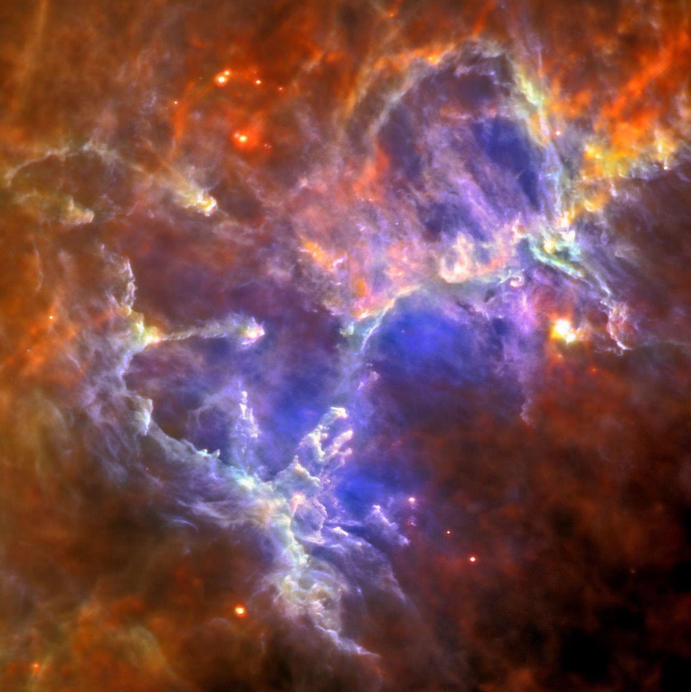 This image of the Eagle nebula shows the self-emission of the intensely cold nebula's gas and dust as never seen before; the nebula's intricate tendril nature, with vast cavities forms an almost cave-like surrounding to the famous pillars.