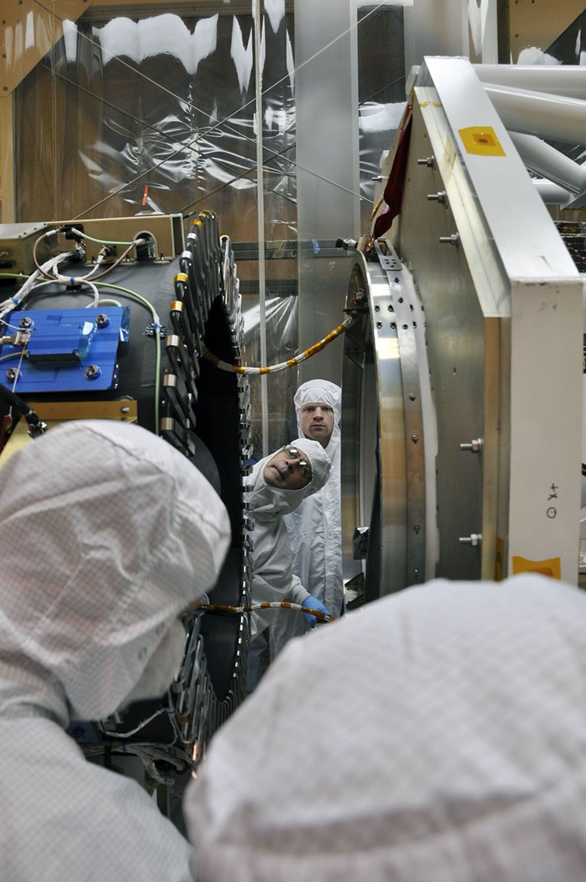 At Vandenberg Air Force Base's processing facility in California, the separation ring on the aft end of NASA's Nuclear Spectroscopic Telescope Array (NuSTAR), at right, inches its way toward the third stage of an Orbital Sciences Pegasus XL rocket.