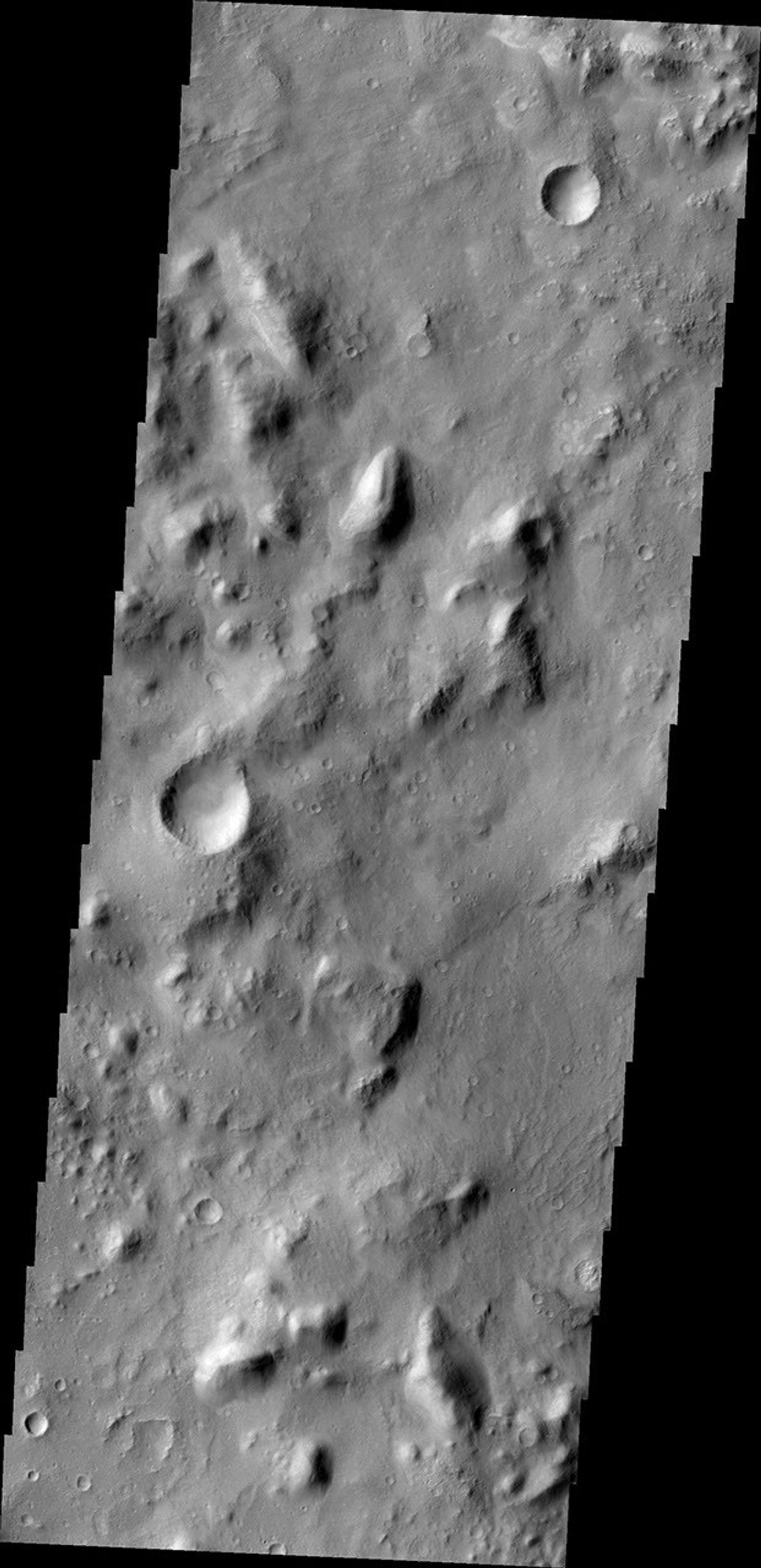 NASA's Mars Odyssey spacecraft captured this image on Feb. 19, 2012, 10 years to the day after the camera recorded its first view of Mars. This image covers an area in the Nepenthes Mensae region north of the Martian equator.