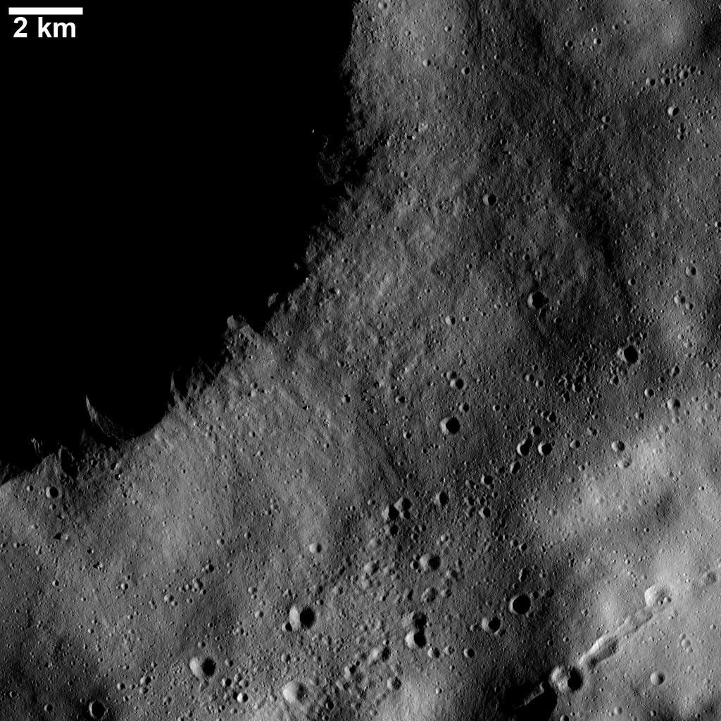 This image from NASA's Dawn spacecraft shows numerous linear chains and clusters of small craters on asteroid Vesta. These chains and clusters of craters were created by material that was ejected during the formation of a large crater.