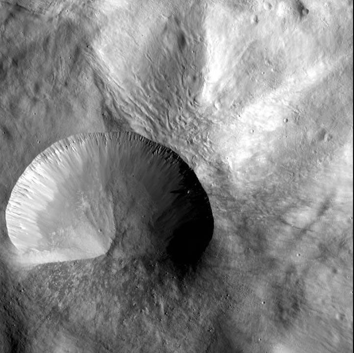 This image from NASA's Dawn spacecraft shows a young crater on asteroid Vesta. Layering is visible in the crater walls, as are large boulders that were thrown out in the material ejected from the impact.