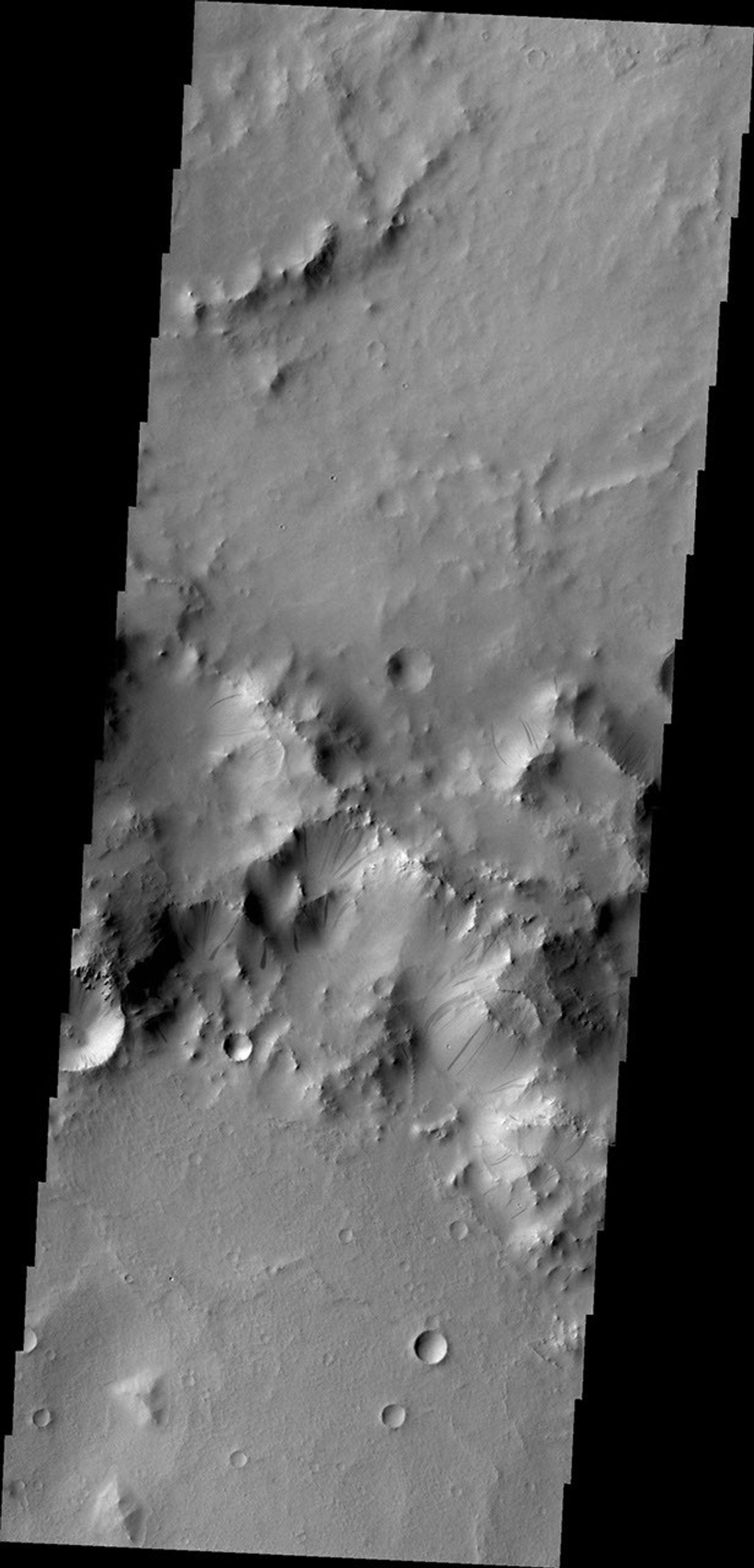Gravity driven slope modification creates the dark marks on the crater rim in this unnamed crater in Terra Sabaea as seen by NASA's 2001 Mars Odyssey spacecraft.