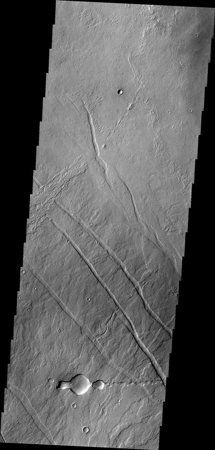 This image from NASA's 2001 Mars Odyssey spacecraft of the Tharsis region illustrates relative age relations. Fractures occurred in old lava flows and then younger lava flows covered the fractures.