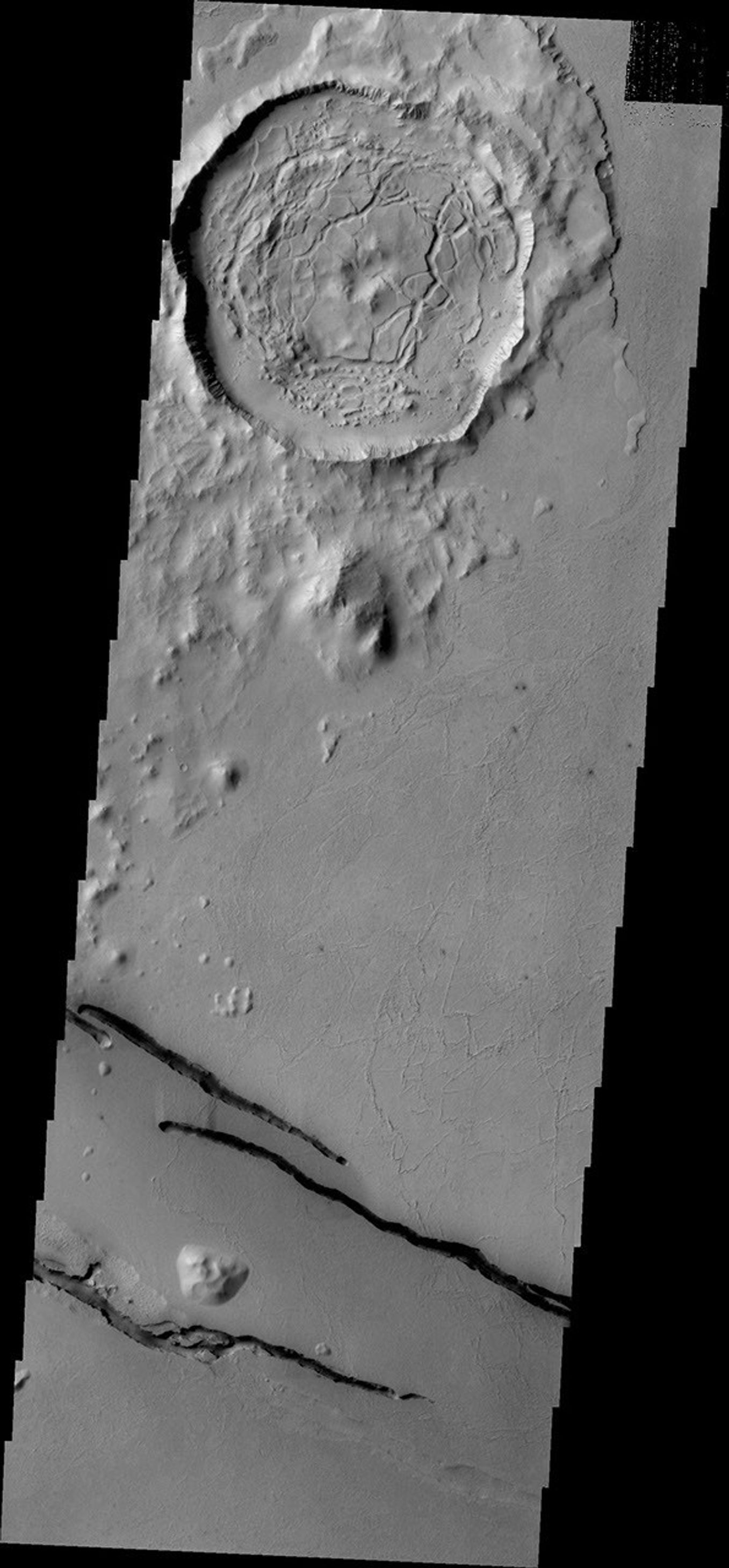 The dark fractures in this image from NASA's 2001 Mars Odyssey spacecraft are part of Cerberus Fossae.