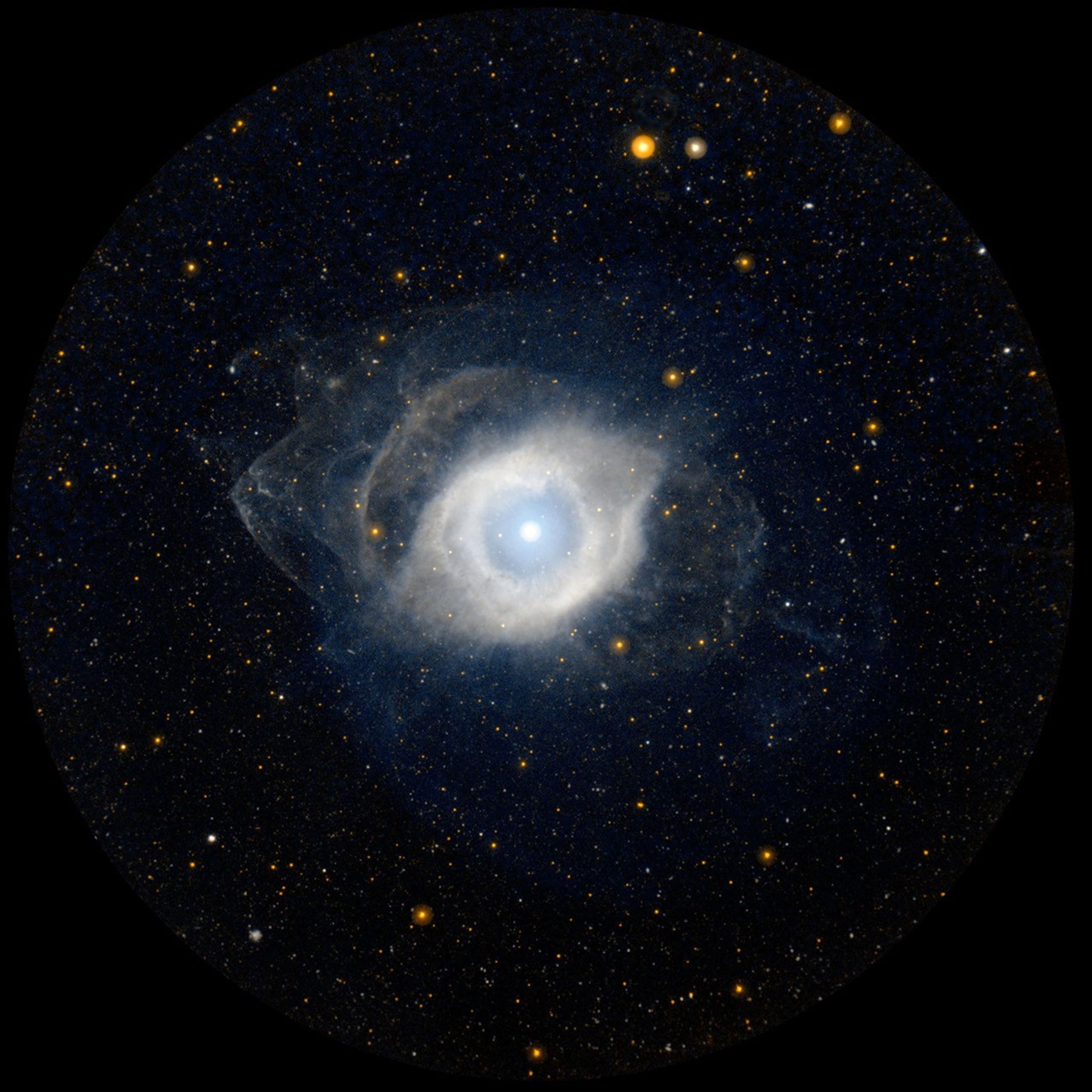NGC 7293, better known as the Helix nebula, displays its ultraviolet glow courtesy of NASA's GALEX. The Helix is the nearest example of a planetary nebula, which is the eventual fate of a star, like our own Sun, as it approaches the end of its life.