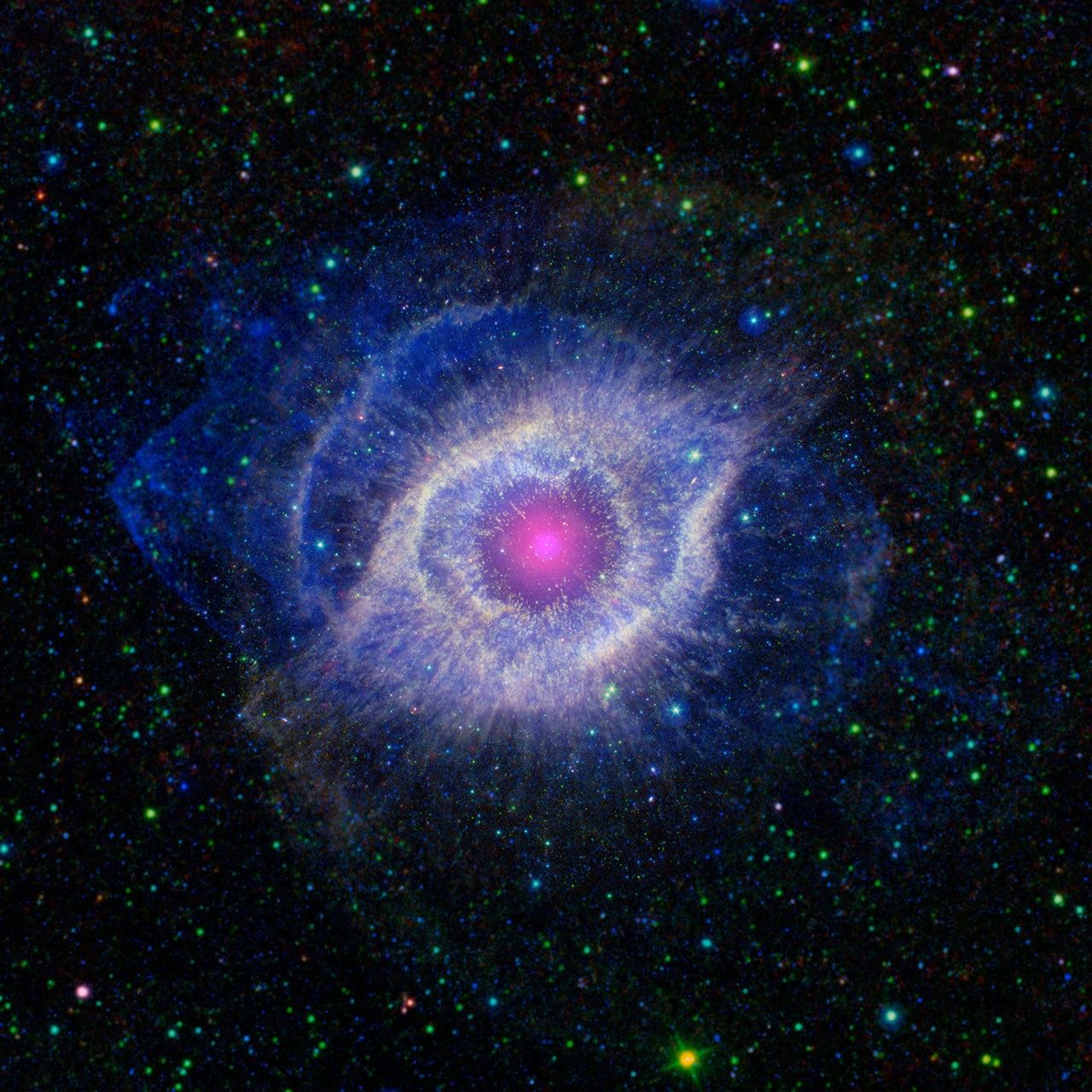This image from NASA's Spitzer and GALEX shows the Helix nebula, a dying star throwing a cosmic tantrum. In death, the star's dusty outer layers are unraveling into space, glowing from the intense UV radiation being pumped out by the hot stellar core.