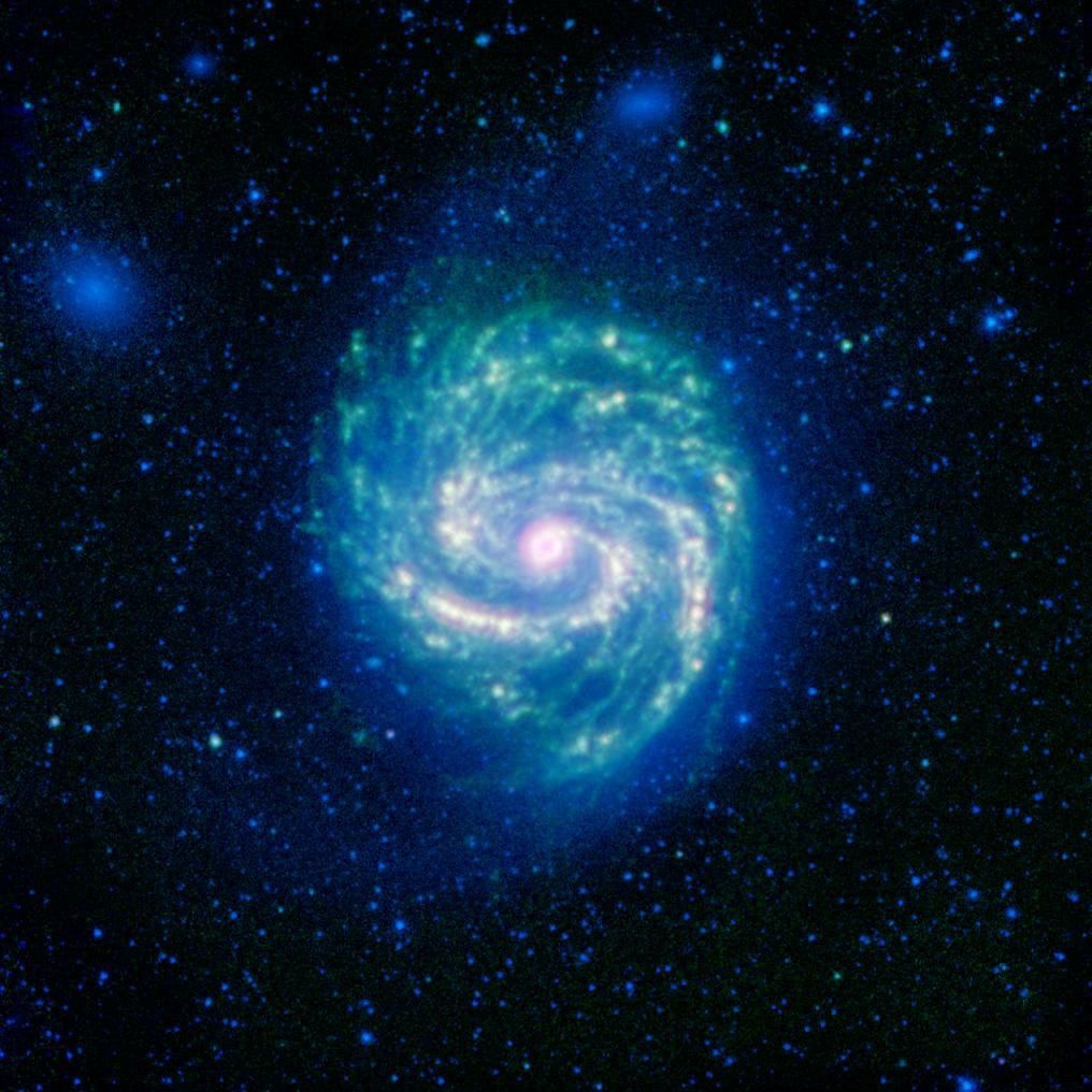 The galaxy Messier 100, or M100, shows its swirling spiral in this infrared image from NASA's Spitzer Space Telescope. The arcing spiral arms of dust and gas that harbor star forming regions glow vividly when seen in the infrared.