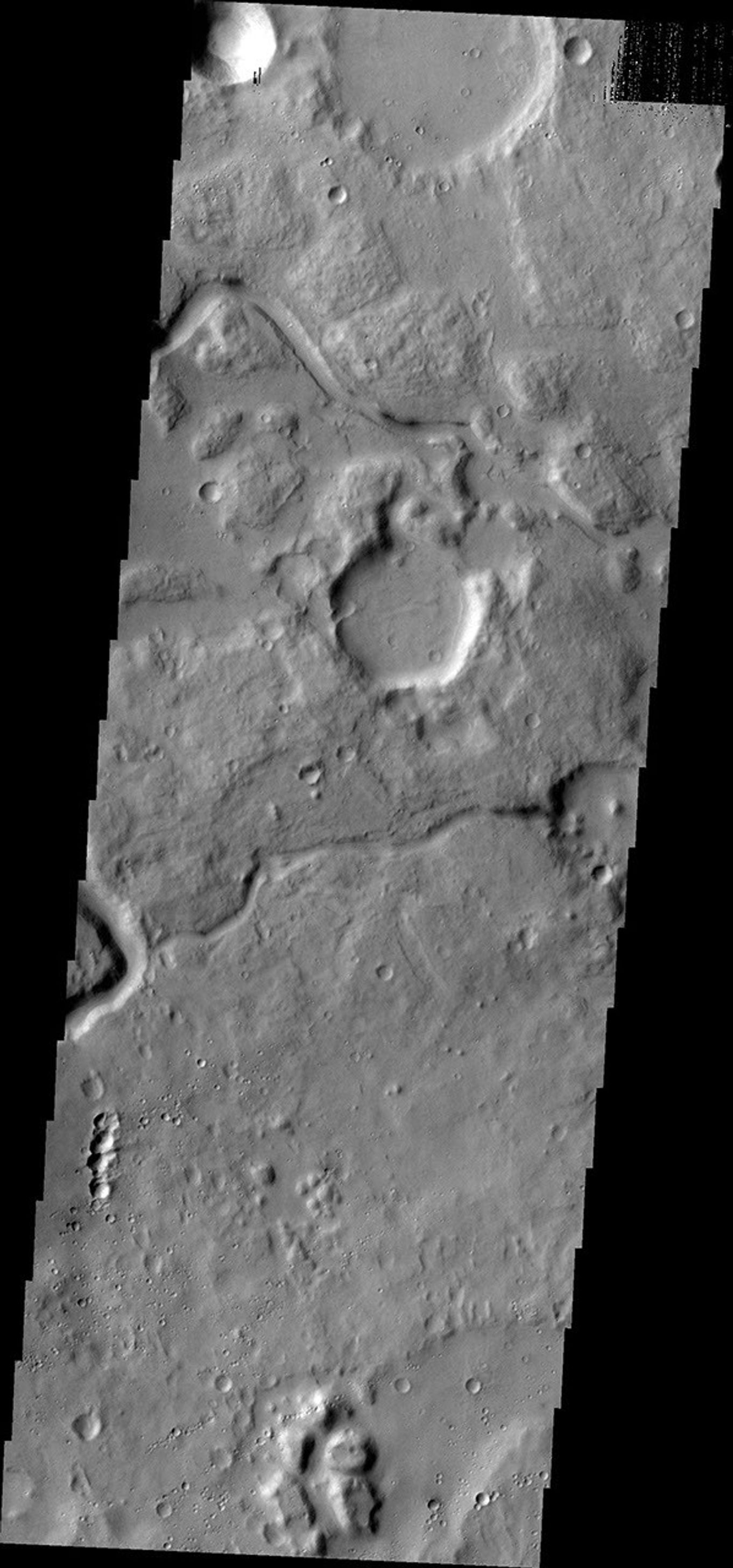 The channels on Mars in this image captured by NASA's Mars Odyssey spacecraft are located between Ares Vallis, a large channel, and Siinka Vallis, a much smaller channel.