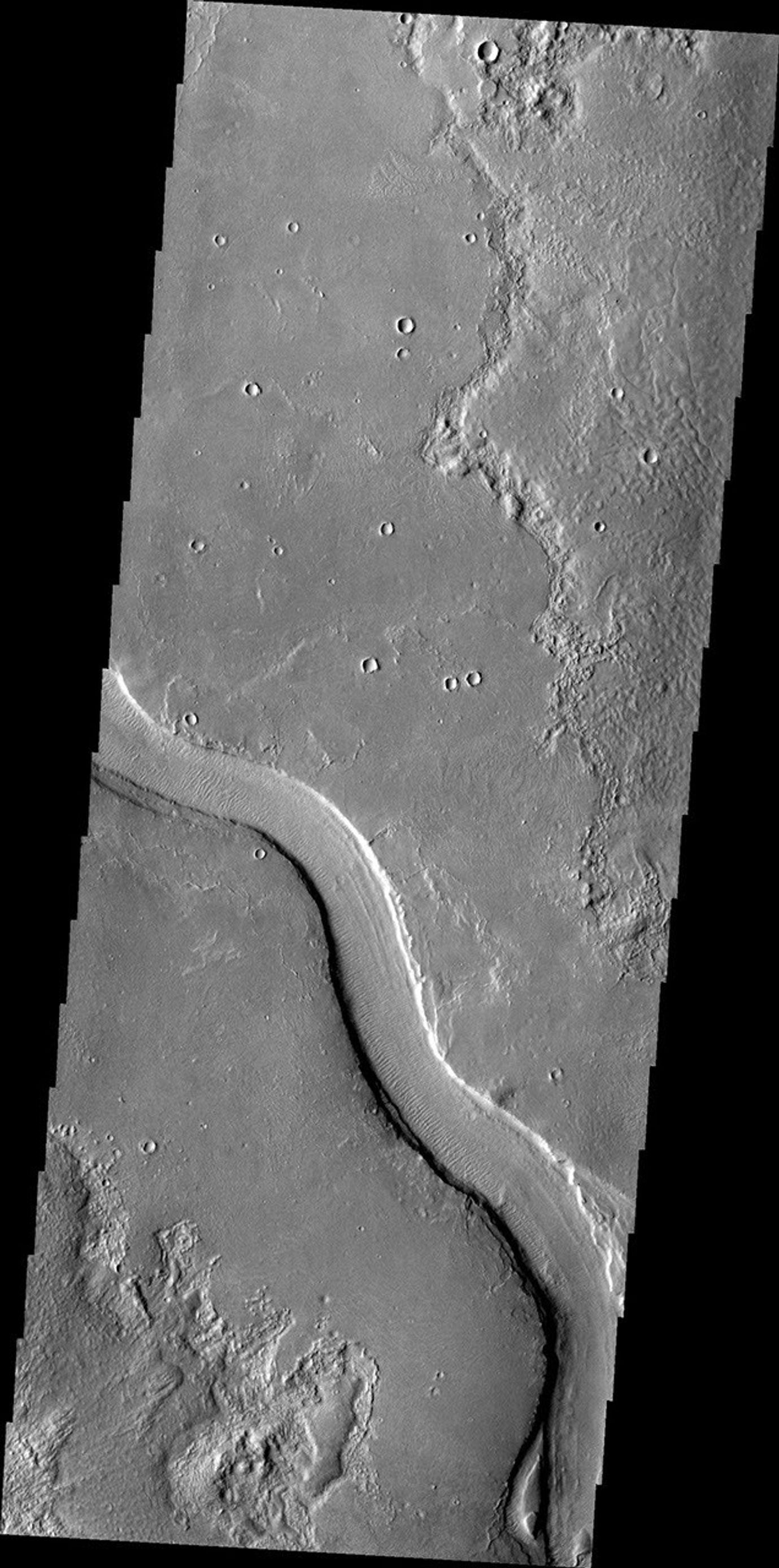 The channel in this image captured by NASA's Mars Odyssey spacecraft is called Hrad Vallis. Hrad Vallis is located on the northwestern margin of the Elysium volcanic complex.