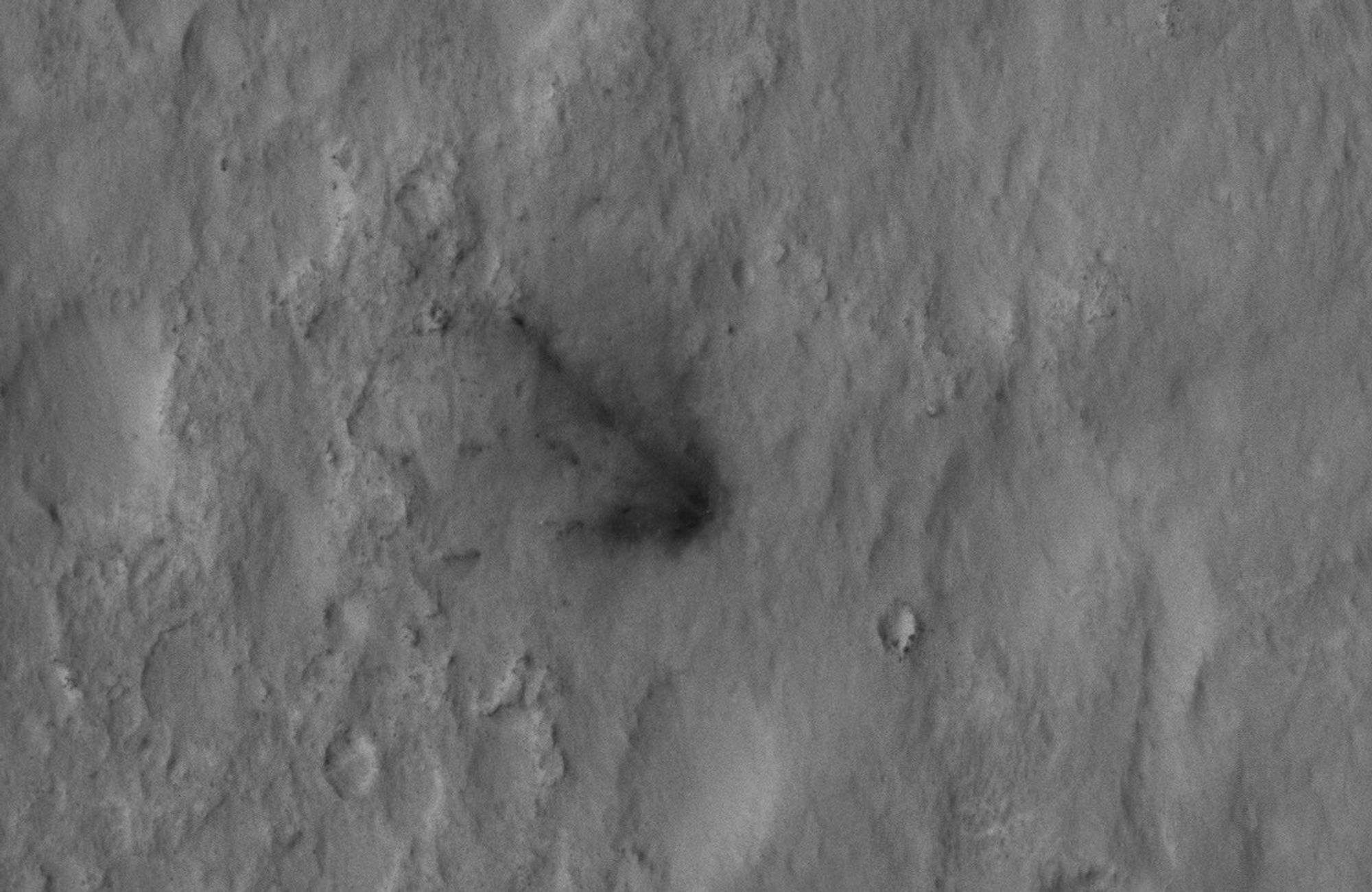 This close-up view captured by NASA's Mars Reconnaissance Orbiter shows darkened radial jets caused by the impact of Curiosity's sky crane, which helped deliver the rover to the surface of Mars.