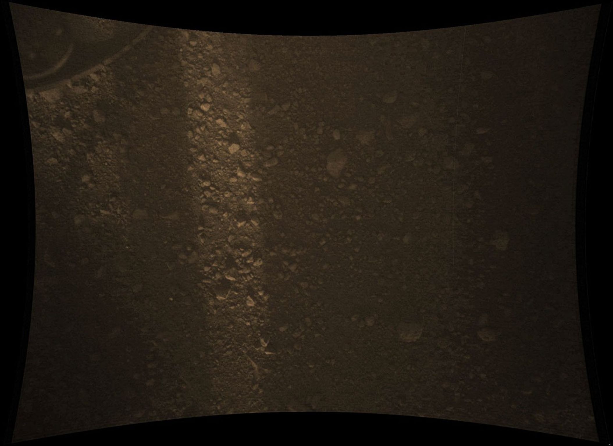 This full-resolution color image from NASA's Curiosity Rover shows the gravel-covered surface of Mars. It was taken by the Mars Descent Imager (MARDI) several minutes after Curiosity touched down on Mars.