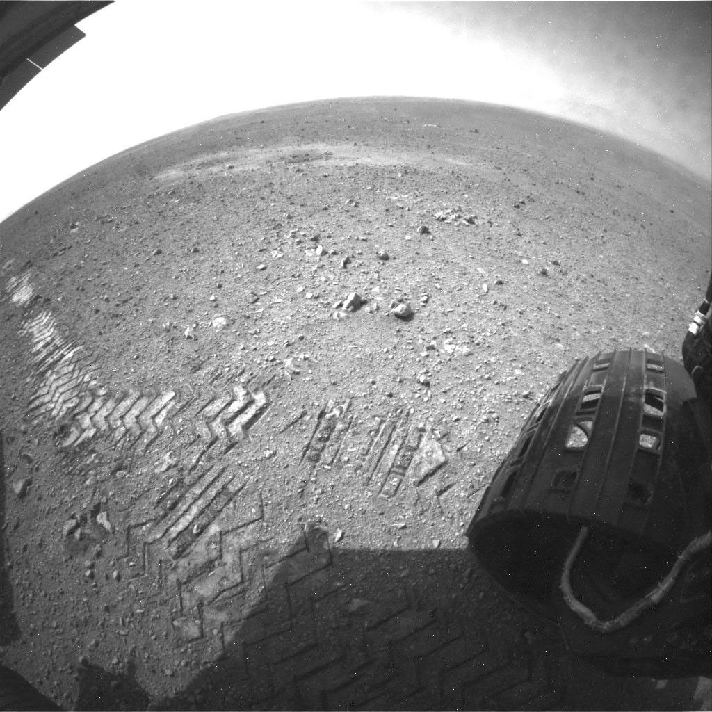This image shows a close-up of track marks left by NASA's Curiosity rover. Holes in the rover's wheels, seen here in this view, leave imprints in the tracks that can be used to help the rover drive more accurately. The imprint is Morse code for JPL.