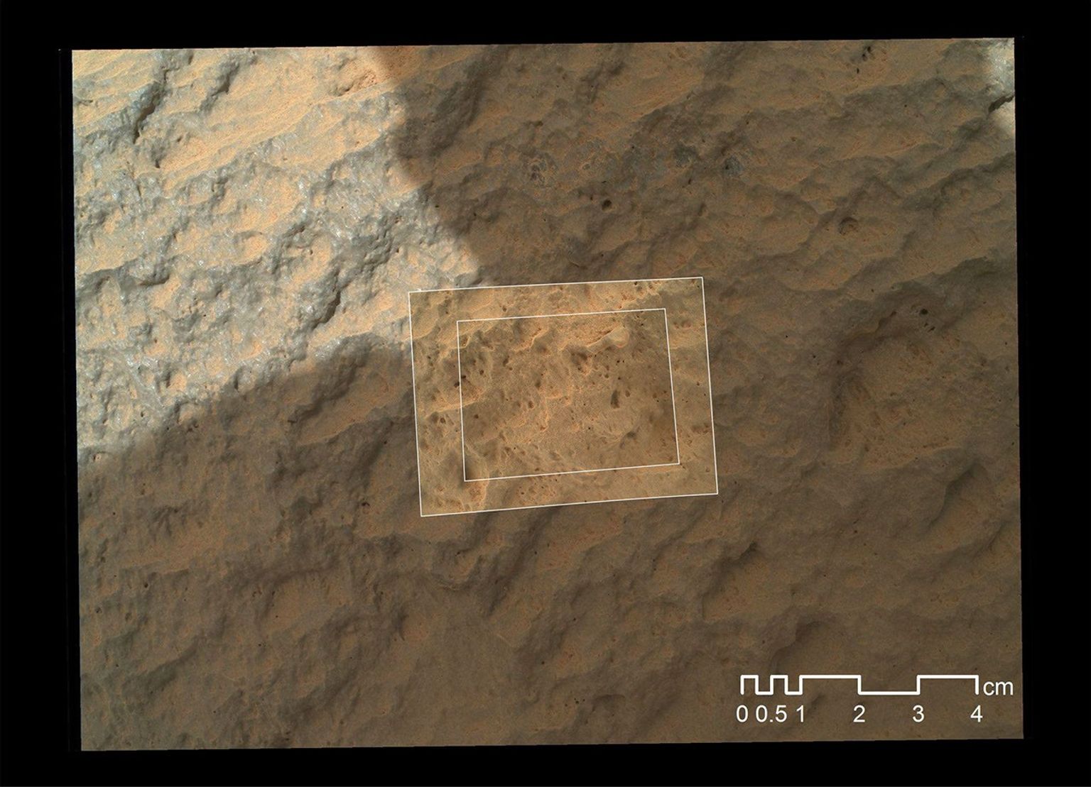 This image combines photographs taken by the Mars Hand Lens Imager (MAHLI) at three different distances from the first Martian rock that NASA's Curiosity rover touched with its arm.