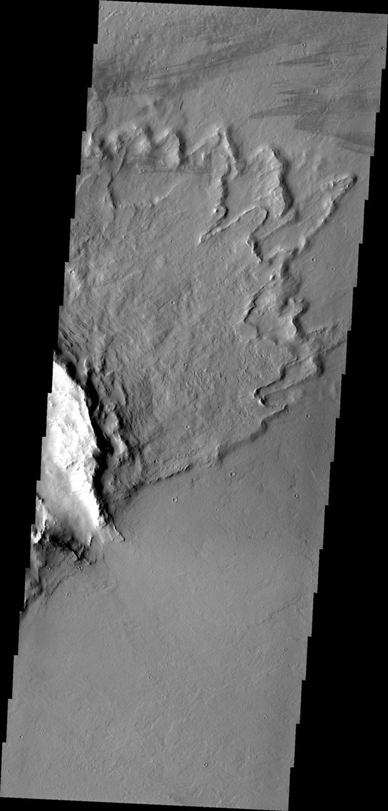 'Butterfly' ejecta is the name given when a crater has two lobes of ejecta on opposite sides, with little or no ejecta between the lobes. This image is from NASA's 2001 Mars Odyssey spacecraft.