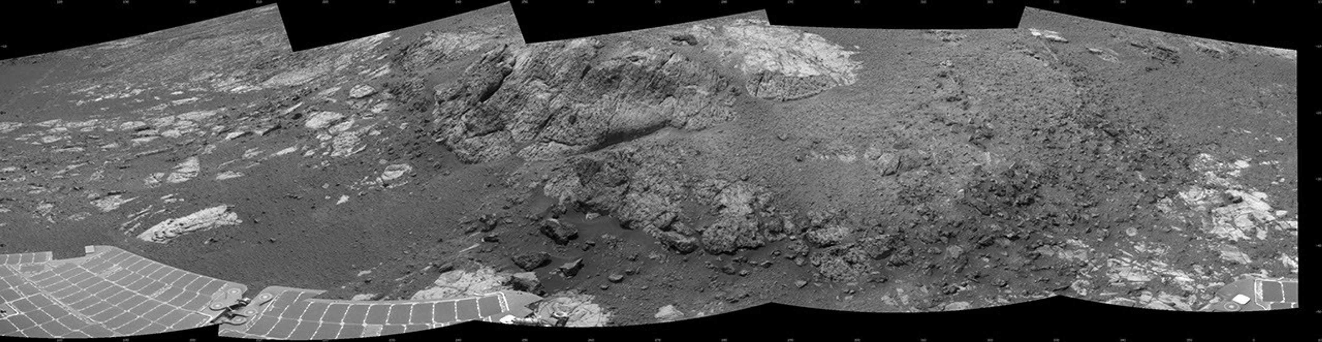 This 180-degree mosaic of images from the navigation camera on the NASA Mars Exploration Rover Opportunity shows the rover close to the outcrop called 'Copper Cliff,' which is in the center of this scene.