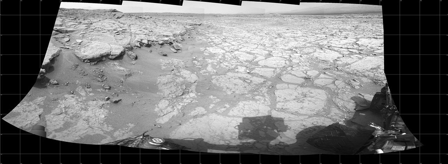 In a shallow depression called 'Yellowknife Bay,' the NASA Mars rover Curiosity drove to an edge of the feature to record this view of the ledge at the margin and a view across the 'bay' during the 130th Martian day, or sol, (Dec. 17, 2012).