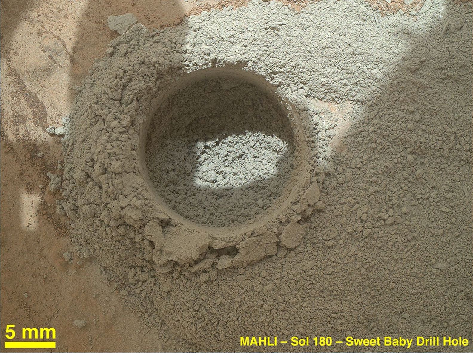 After an activity called the 'mini drill test' by NASA's Mars rover Curiosity, the rover's MAHLI camera recorded this view of the results. The test generated a ring of powdered rock for inspection in advance of the rover's first full drilling.