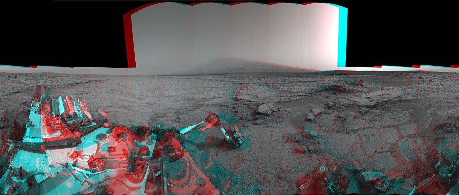 In the center foreground, NASA's Curiosity rover's arm holds the tool turret above a target called 'Wernecke' on the 'John Klein' patch of pale-veined mudstone.