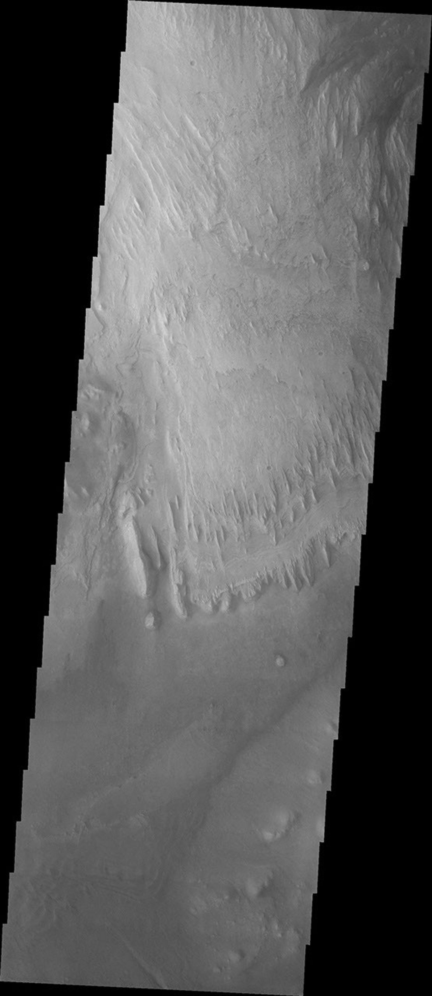 This image from NASA's Mars Odyssey spacecraft shows a dark region on the Gale crater floor of Mars made of sand. The dunes that encircle Mt. Sharp are most likely comprised of sand eroded from Mt. Sharp itself.