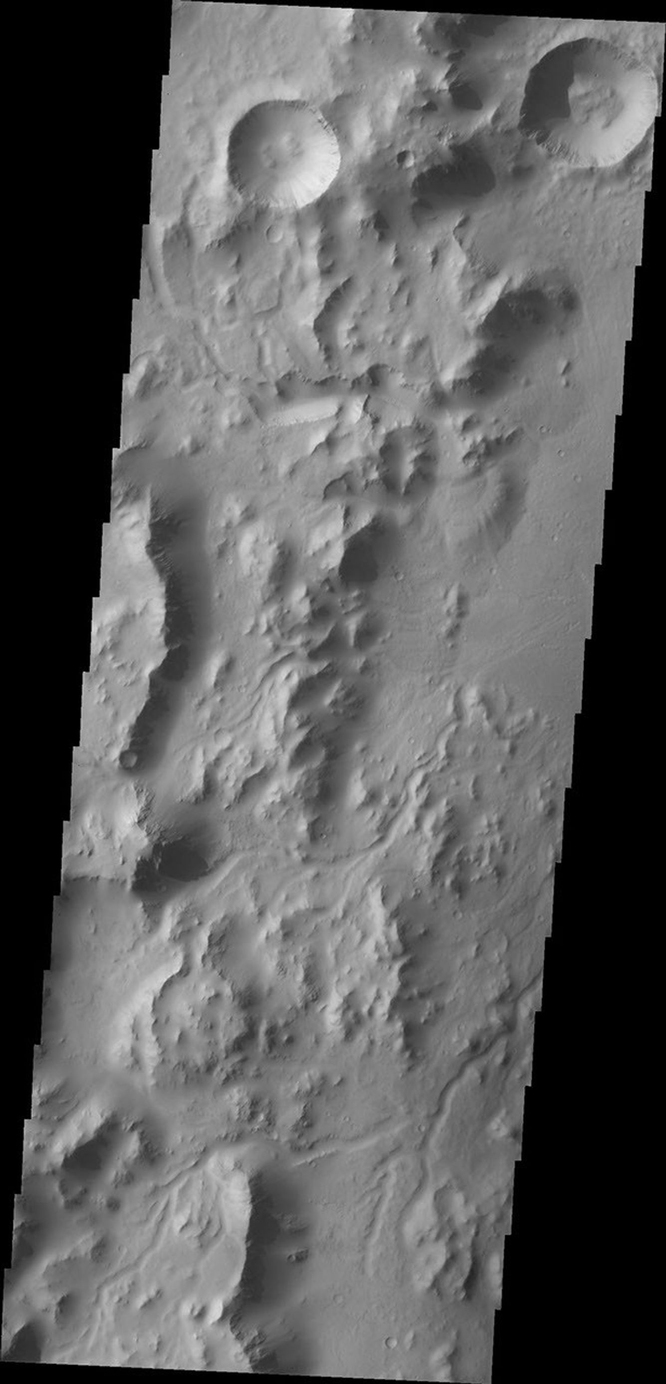 This image from NASA's Mars Odyssey spacecraft shows the western rim of Gale Crater. Several channels dissect the rim of the crater.