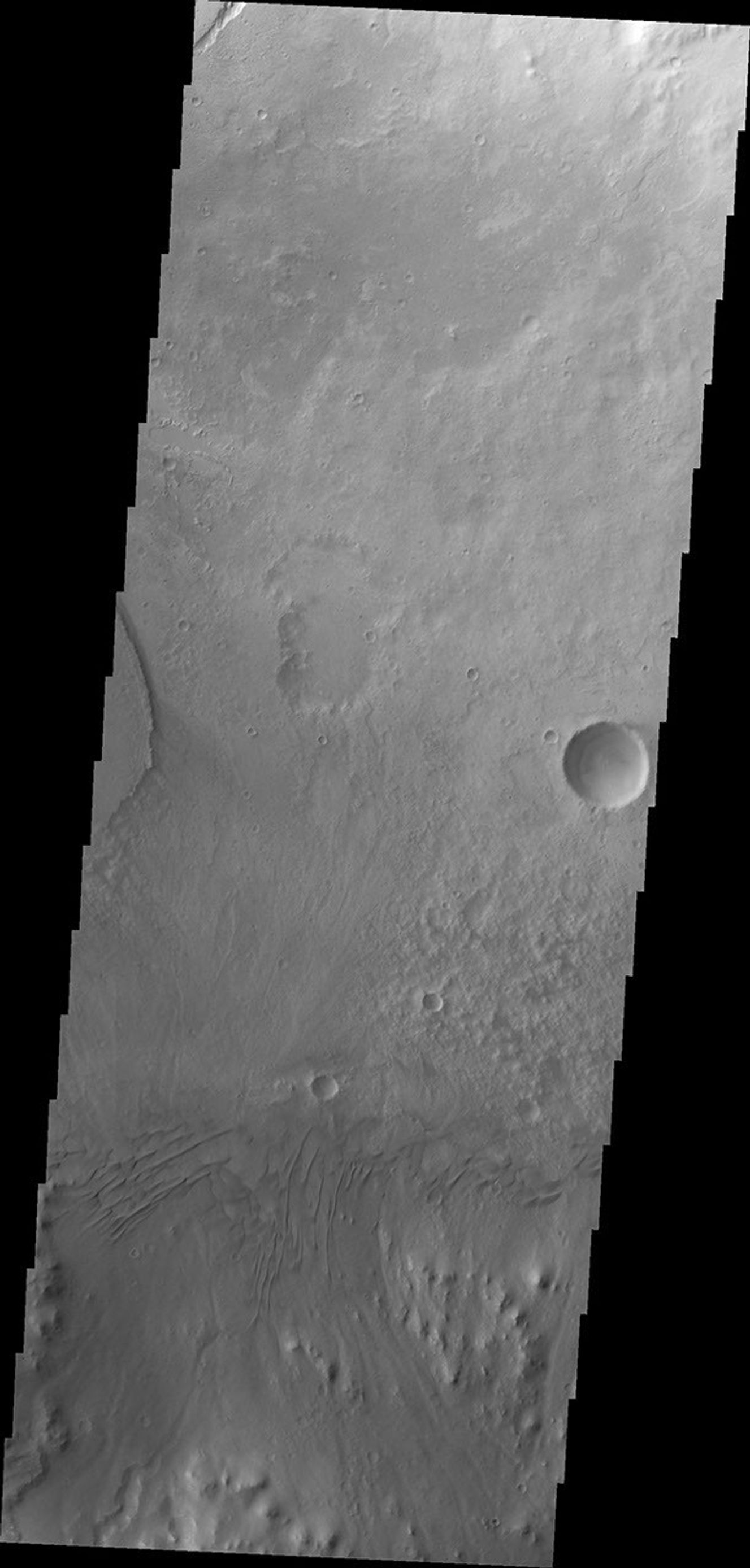 Moving eastward across the southern part of Gale Crater, this image from NASA's Mars Odyssey spacecraft shows the easternmost arc of the channel deposit at the far left edge. Towards the bottom of the frame are sand dunes.